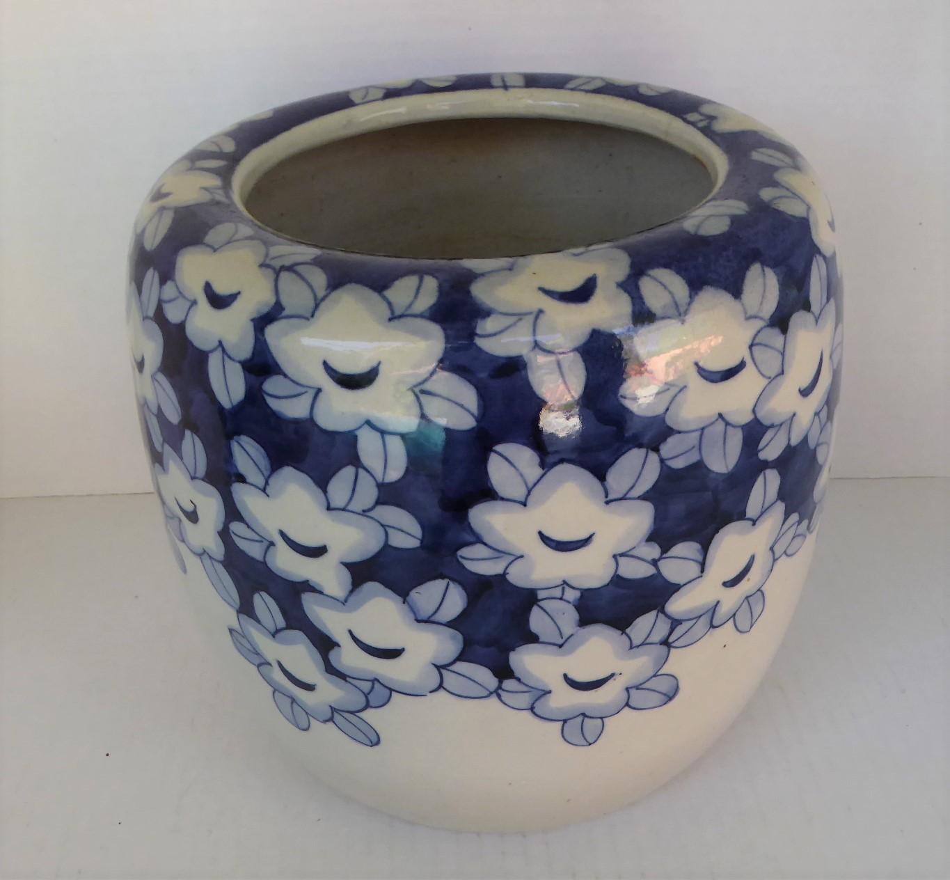 1950s Asian Modern earthenware Hibachi from Japan. Lovely decoration of blue and white large blooms with leaves, probably Plum or Peach blooms, signifying perseverance and hope. The flowers are like little faces enjoying the coming of spring,