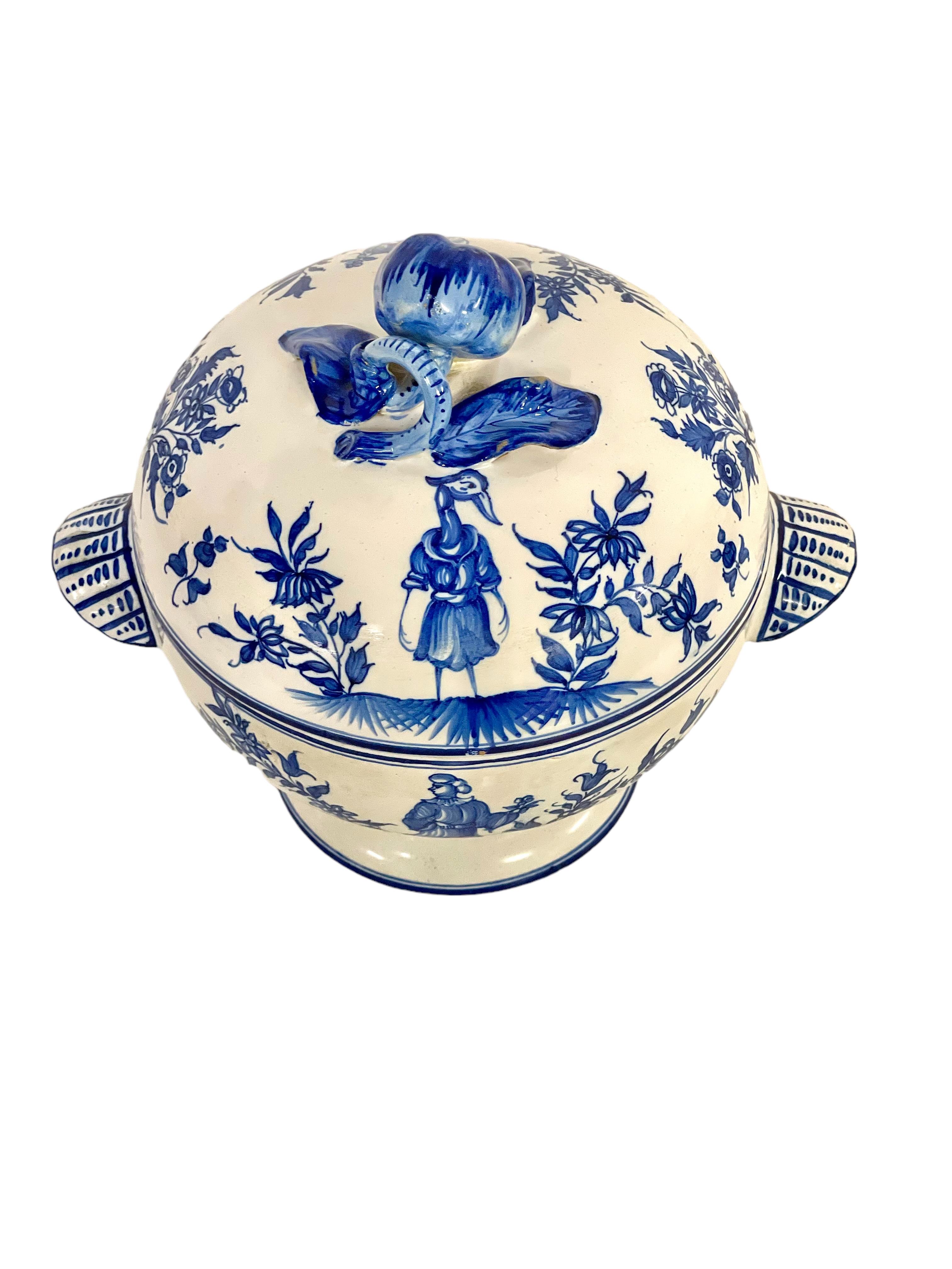 This pretty little earthenware soup tureen dates from the 19th century, and is hand-painted in classic blue and white. Upon closer inspection, however, the decoration on both bowl and lid is rather outlandish and features, in addition to a number of