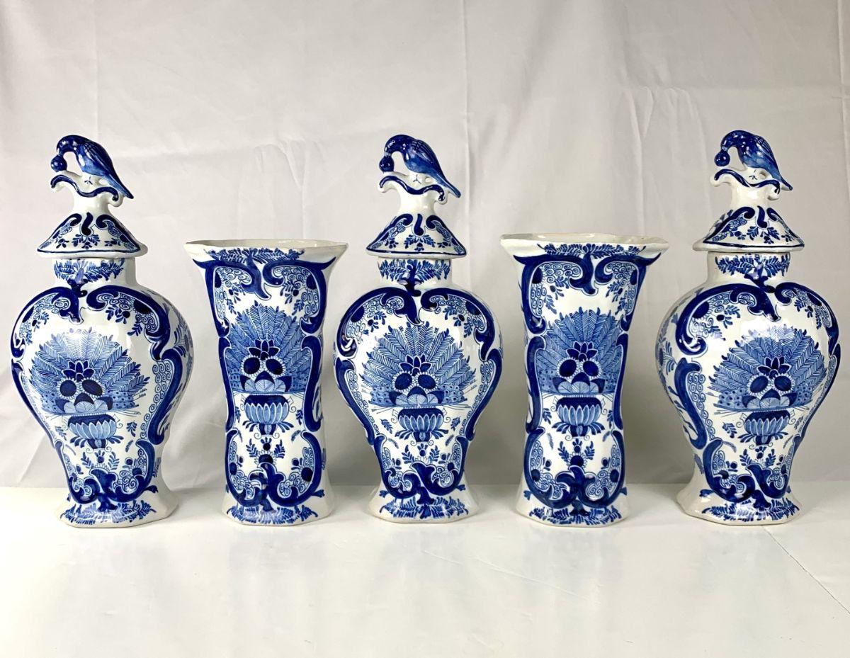This exquisite blue and white Dutch Delft five-piece garniture is painted in beautiful cobalt blue.
It was made in the Netherlands in the late 19th century, circa 1880.
We see a vase filled with sunflowers and ferns.
The stunning design is