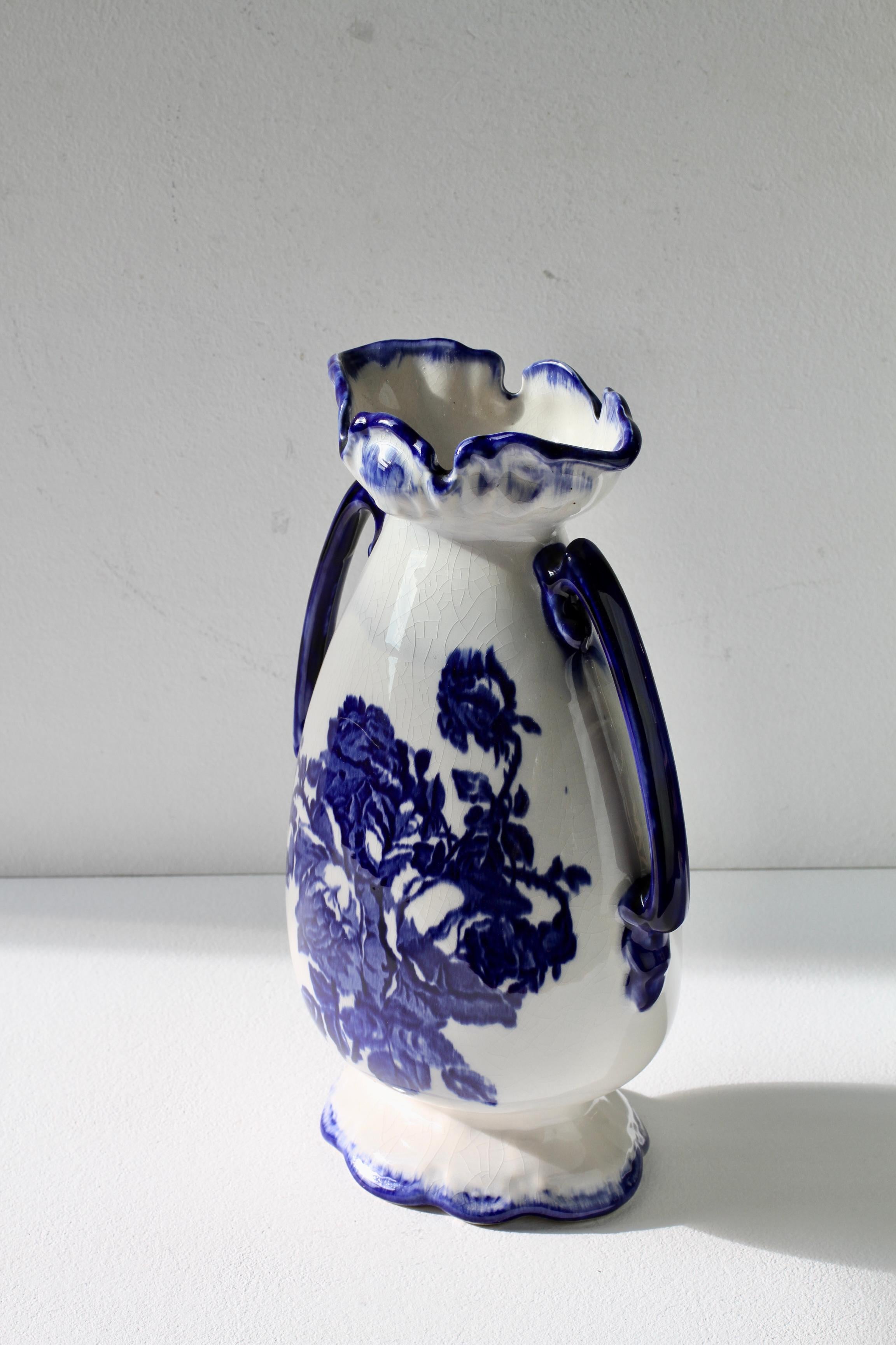Delightful double handled Staffordshire Ironstone vase with Victorian style blue flower motif / design. Add a splash of color / colour to your home decor with this beautiful blue and white crackle glazed vase or vessel. Lovely shape and easy to