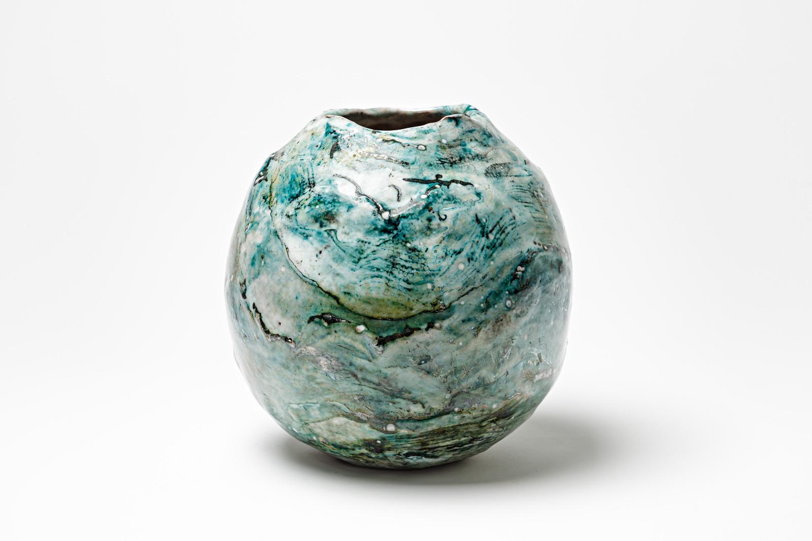 Blue and white glazed ceramic vase by Gisèle Buthod Garçon. 
Raku fired. Artist monogram under the base. Circa 1980-1990. 
H : 8.7’ x 7.4’ inches.
