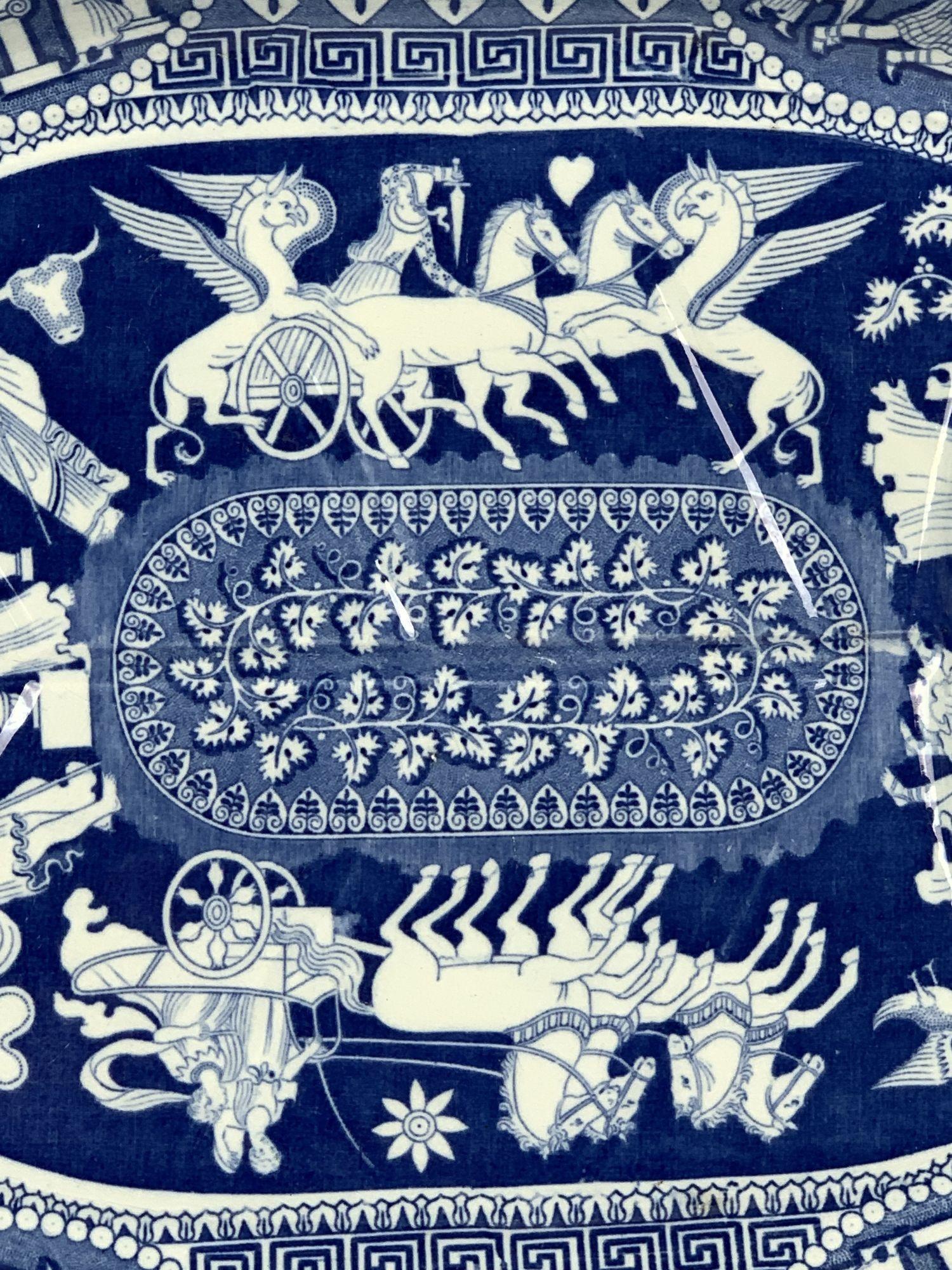 WHY WE LOVE IT: The bold blue and white neoclassical design, the chariots, the flying horses, and the Greek key border.
This early 19th-century blue and white well and tree platter is decorated in a Greek ware pattern made by Herculaneum in England