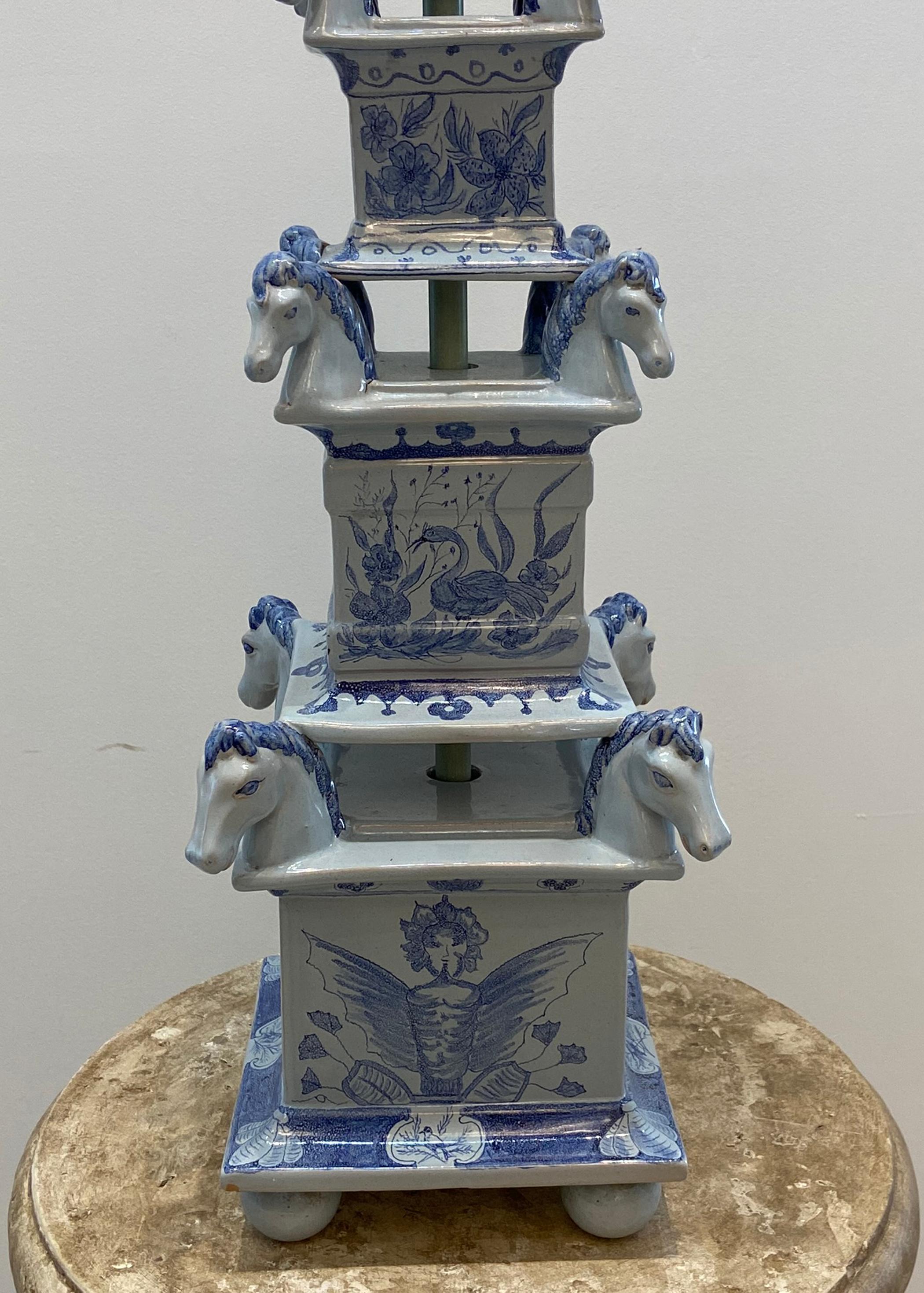 Vintage Asian style blue with white background horse head table lamp. Obelisk shaped with horse heads on each corner.