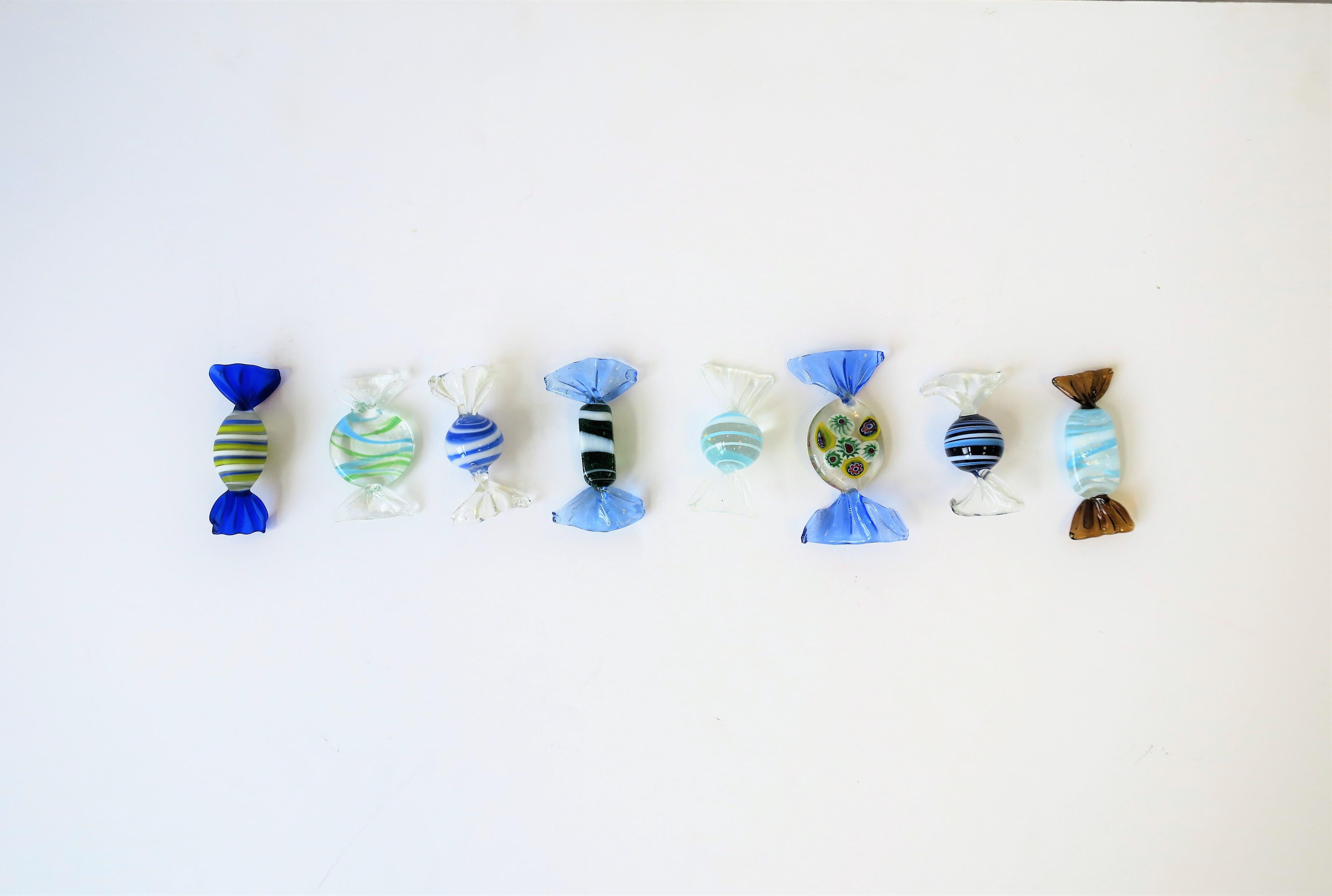 Eight (8) beautiful blue and white Italian Murano art glass candy, Italy. Pieces are handblown. Colors include: blue, white, clear and a touch of yellow. Candies are in various shapes, swirls, and stripes, including one with a millefiori design