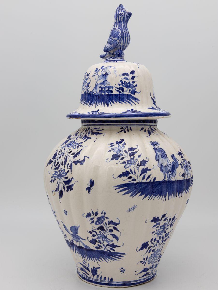 A 20th Century Delft style ginger jar with bird handle lid. Painted in the classic delft blue on white.