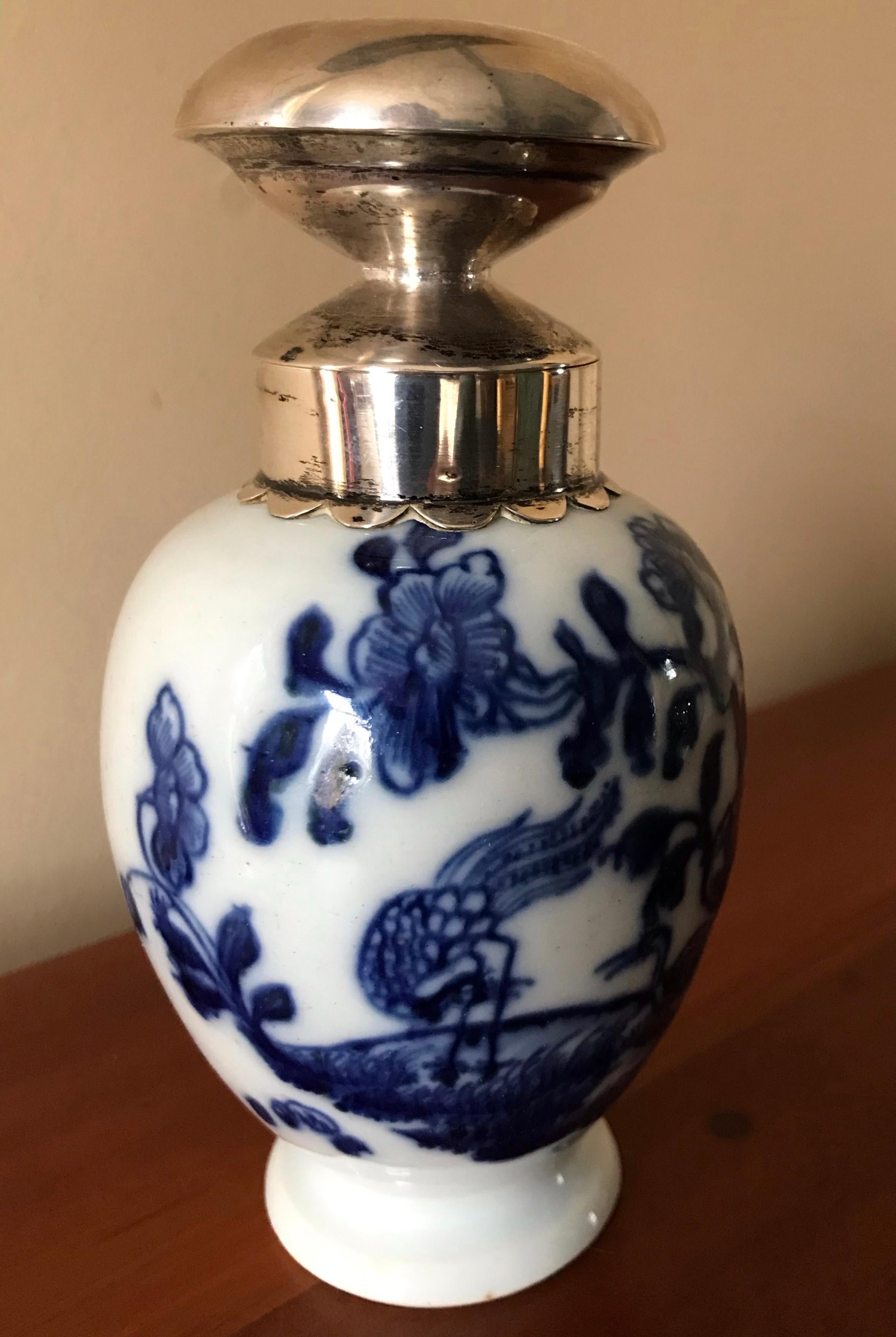Blue and white Kang-xi tea caddy with silver stopper. Late 18th century Chinese tea caddy with cranes in landscape with floral sprigs. Dutch silver mounted collar and stopper. China, late 18th century. 
Dimensions: 5.5” H to top of stopper, 4 3/8”
