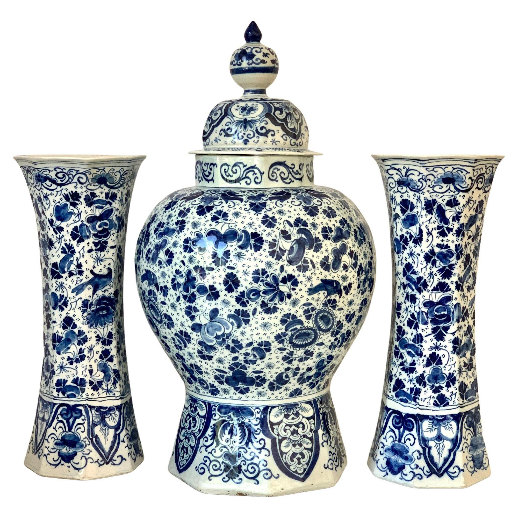 This magnificent blue and white Dutch Delft garniture was hand-painted at De Drie Vergulde Astonnekens (The Three Golden Ash Barrels) three hundred years ago.
This group consists of a single covered jar, a pair of gourd-shaped vases, and a pair of