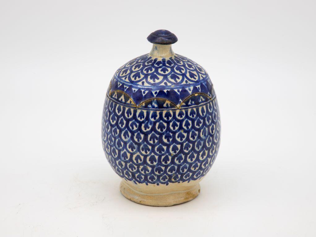 A beautiful handpainted Fes ceramic butter dish or pot with an unusual scalloped lid. Brightly colored in blue and white. This Moroccan Jojoba butter dish is from Fes, Morocco and was made at the end of the 19th century. Wear consistent with age and