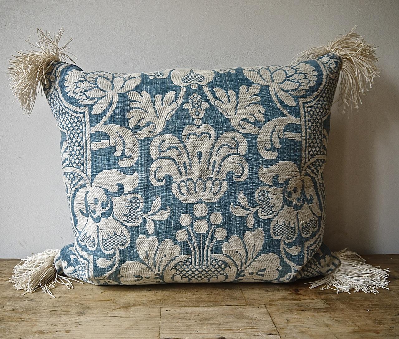 French, circa 1760s woven blue and white linen and cotton cushion. Wonderful texture and contrast of weaves and yarns. Antique French linen fringing at the corners and backed in a dyed 19th century, French linen. Slip-stitched closed with a duck