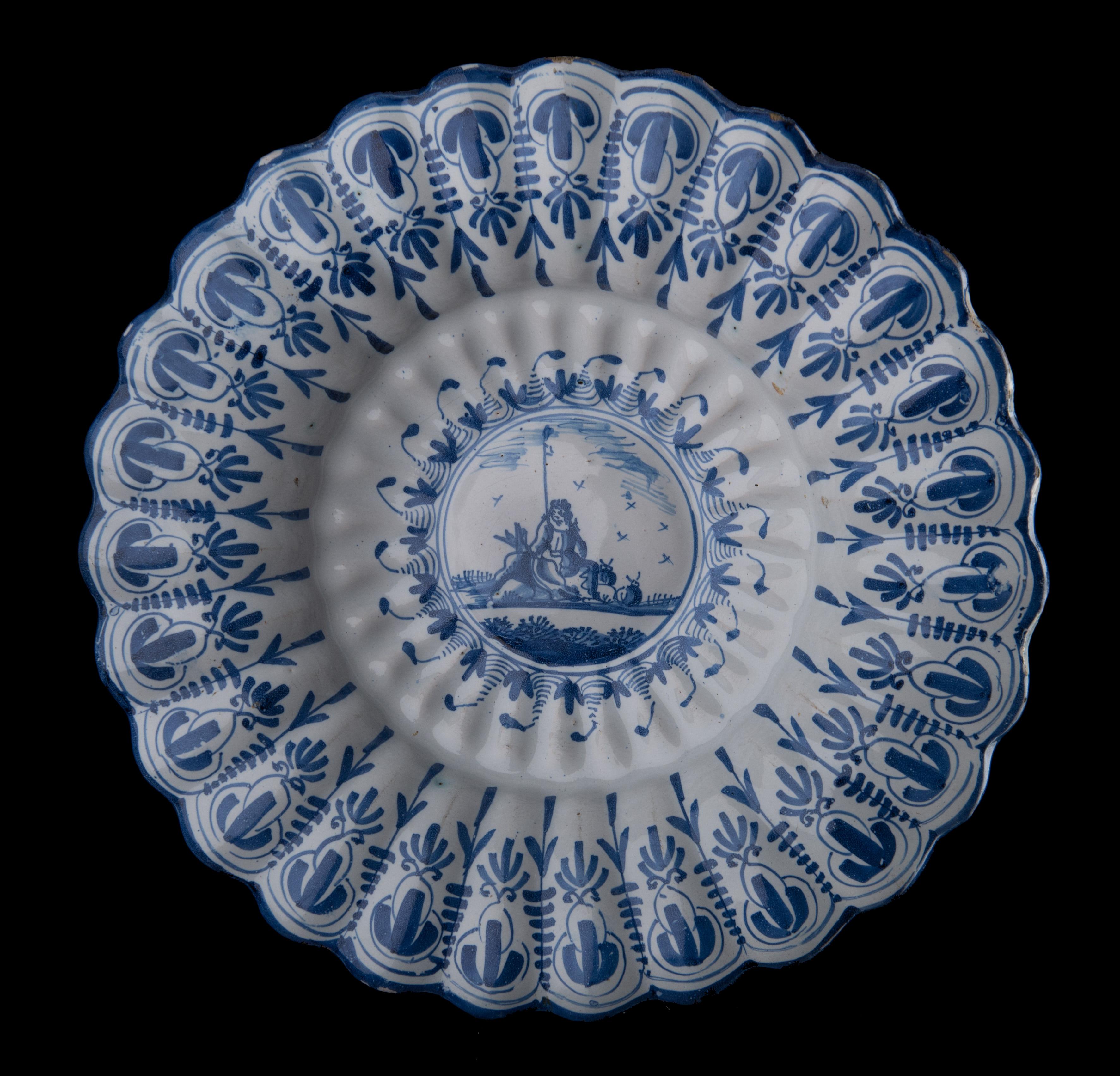 Blue and white lobed dish with shepherd. Northern Netherlands, 1650-1680. 
Dimensions: diameter 33,5 cm / 13.18 in. 

The blue and white dish is composed of twenty-seven double lobes around a curved center. It is painted with a shepherd holding a