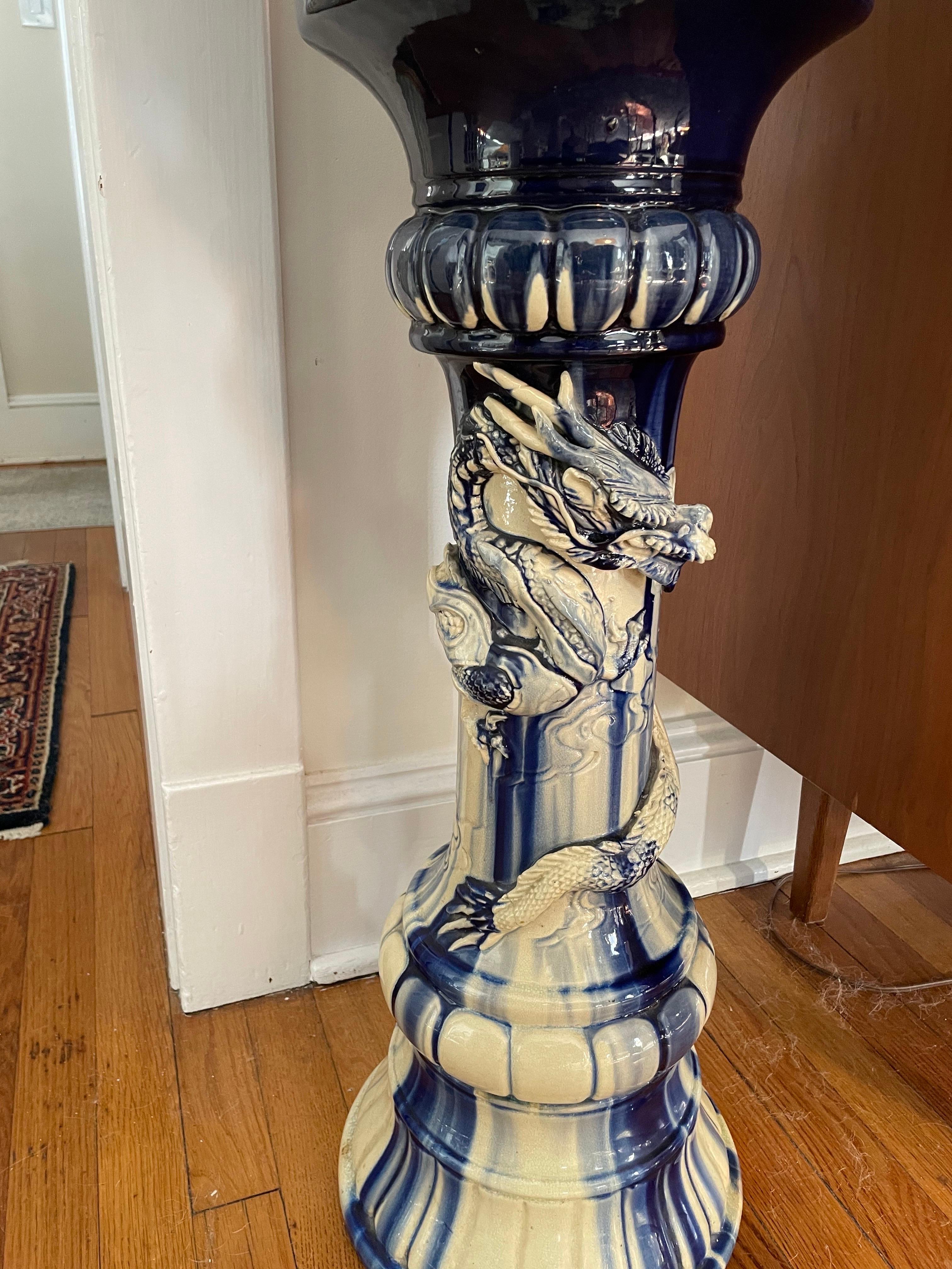 Blue and white painted Majolica urn on stand detailed with Dragon relief. Wonderful marbleized or flambe finish.
Curbside to NYC/Philly $300