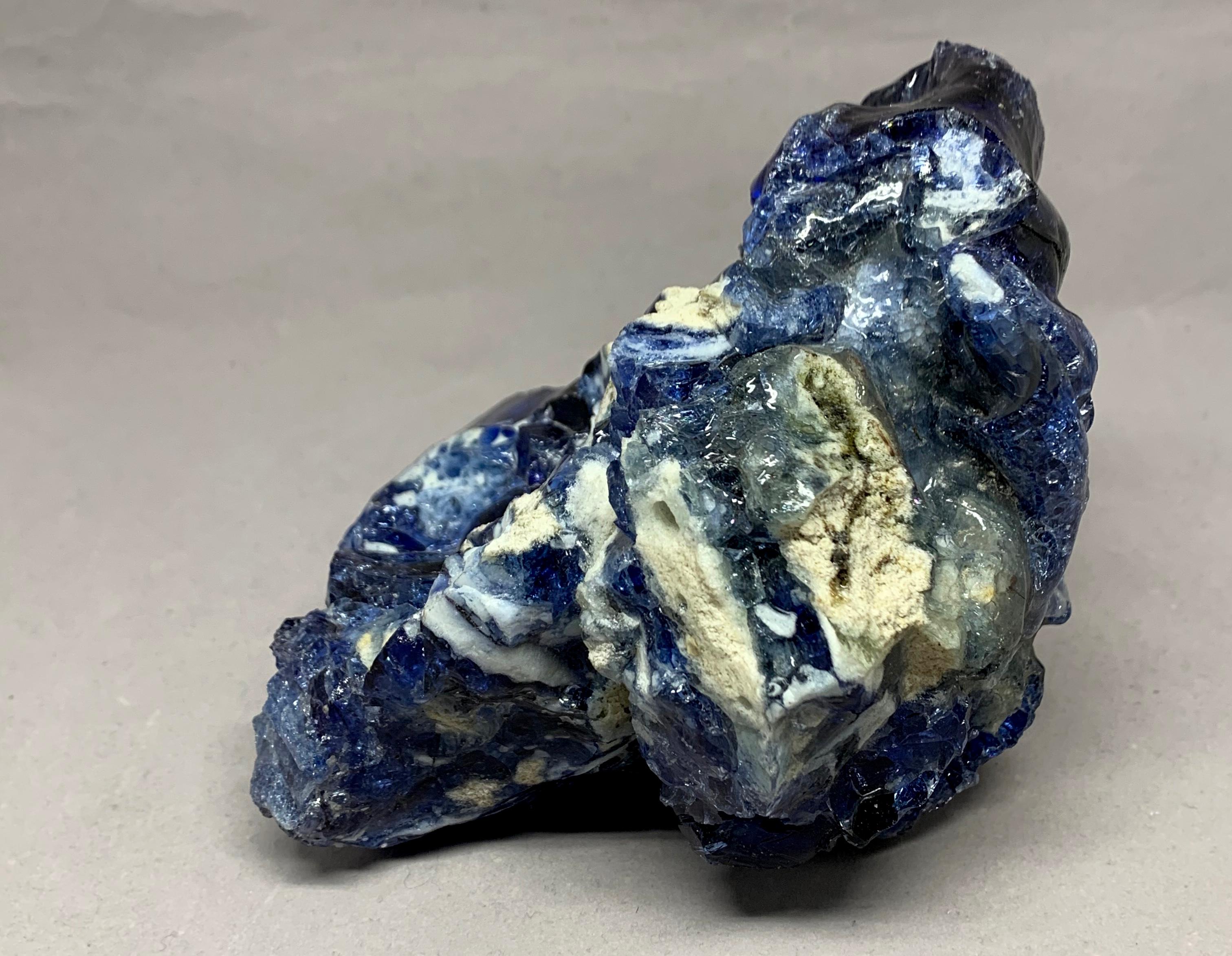 Blue and white natural glass specimen. Chunky natural glass of clear and dark blue and white aggregate for bookshelf or paperweight. 
Dimensions: 6