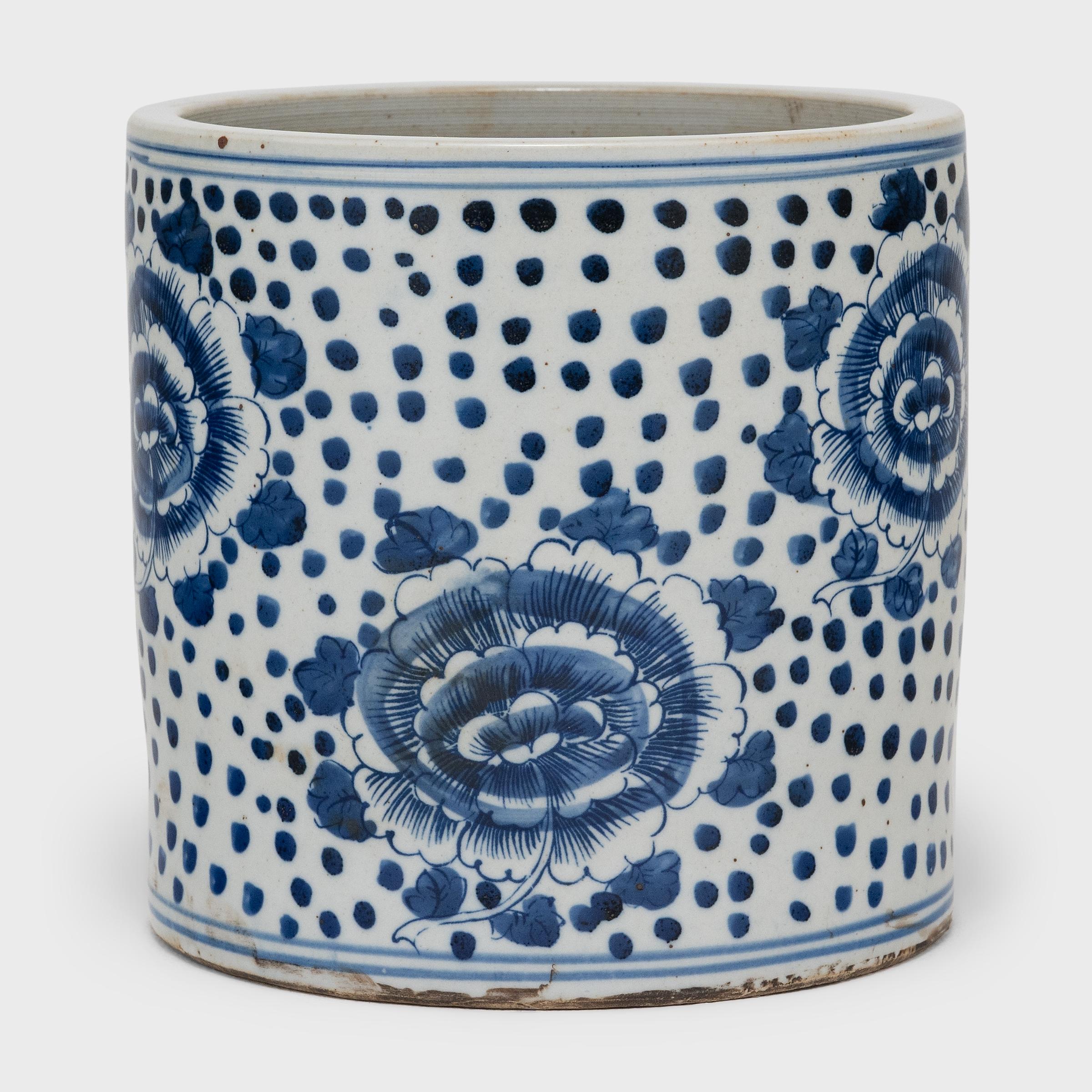 Set alongside the four treasures of the study - the calligraphy brush, ink, paper, and inkstone - a brush pot, or bitong, was an essential fixture of the scholars' desk. This porcelain brush pot beautifully exemplifies this traditional form with the