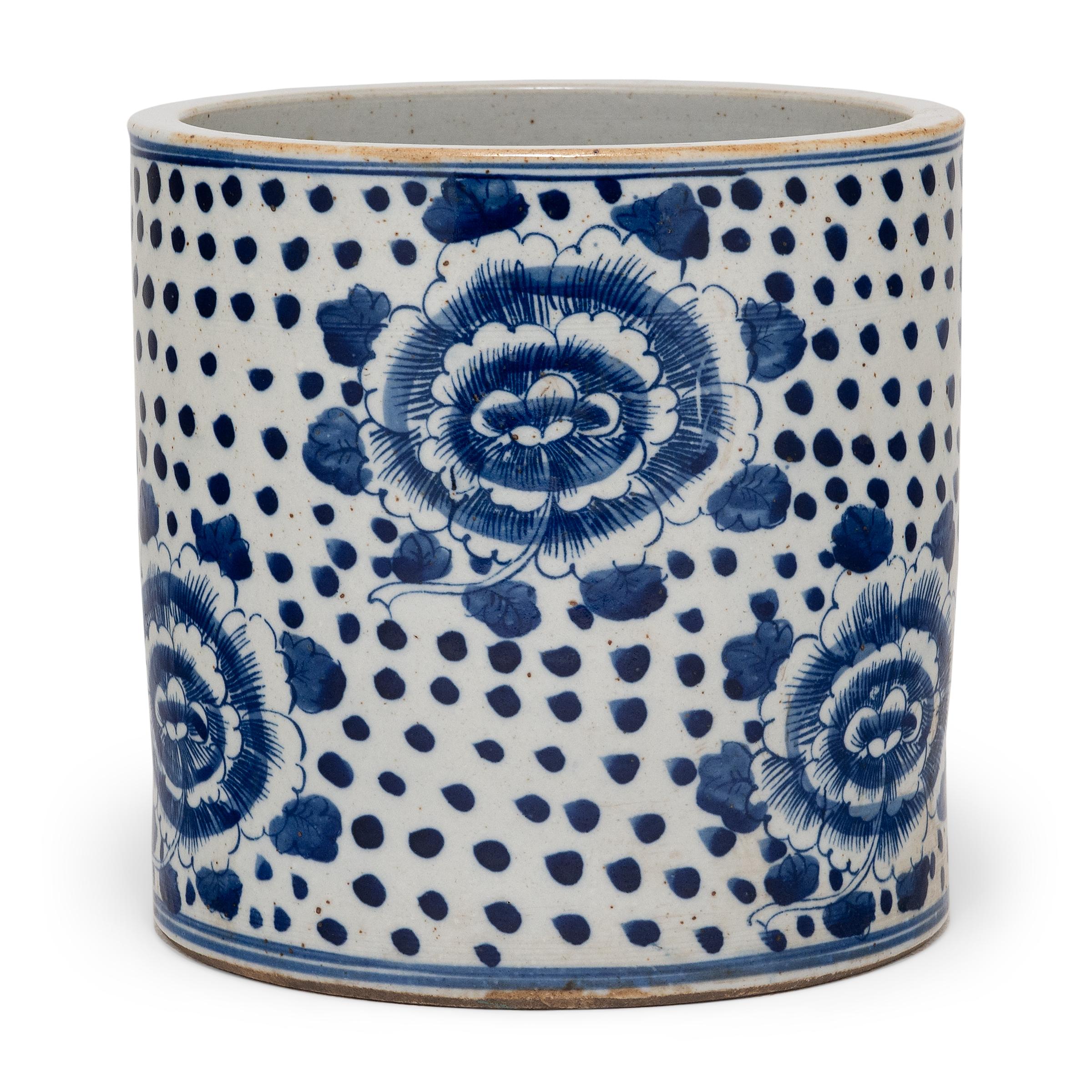 Set alongside the four treasures of the study - the calligraphy brush, ink, paper, and inkstone - a brush pot, or bitong, was an essential fixture of the scholars' desk. This porcelain brush pot beautifully exemplifies this traditional form with the