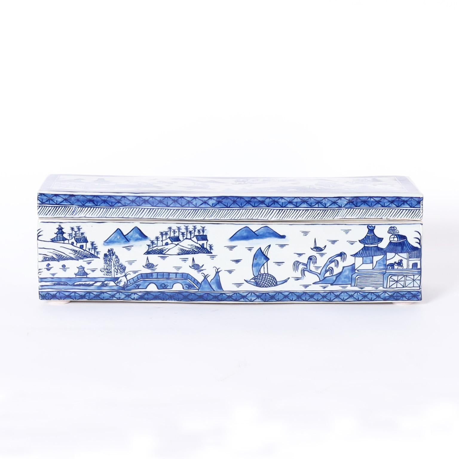 Chinese blue and white porcelain lidded box with a rectangular form hand decorated with land and seascapes.