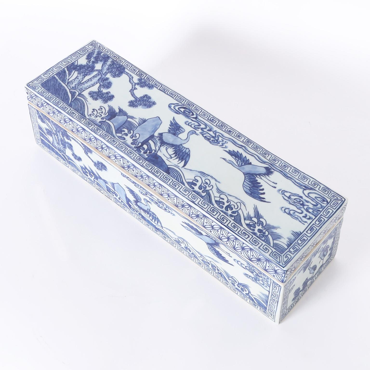 Unusual Chinese blue and white porcelain lidded box hand decorated with birds and trees with geometric borders. The inside has three compartments.