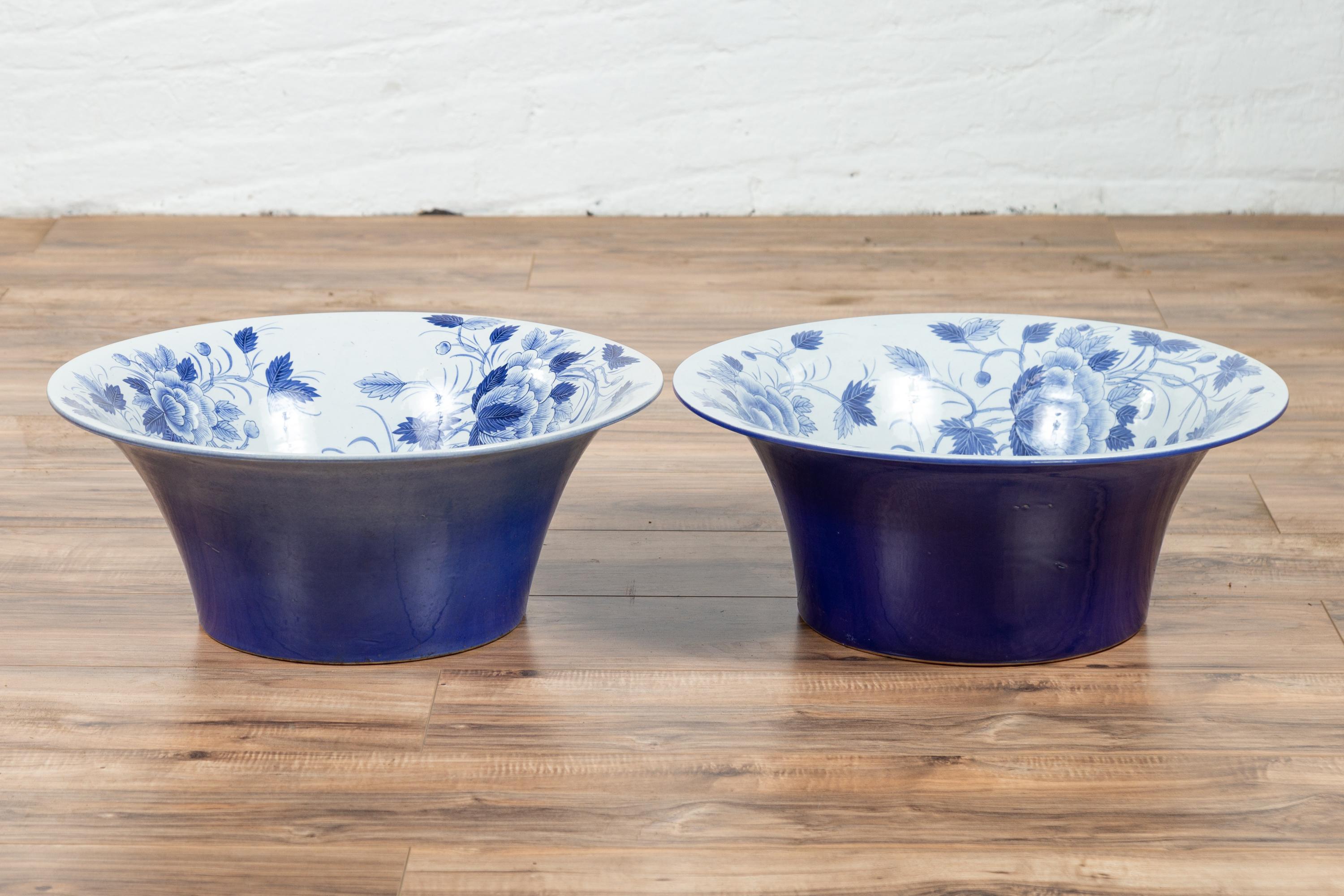 Vintage Thai blue and white porcelain wash basins with cobalt blue patina and floral motifs, priced and sold individually (four available). Each adopting a wide open shape flaring in the upper section, these wash basins are adorned with blue