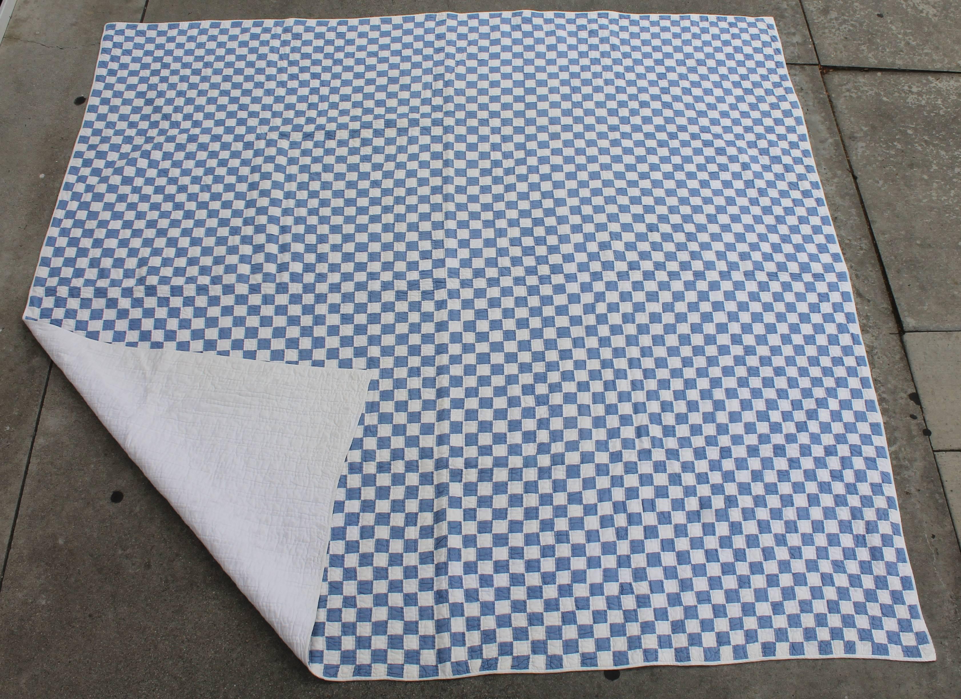 This large quilt in blue and white small pieces is in great condition and nicely pieced. This quilt would fit a queen or king bed.