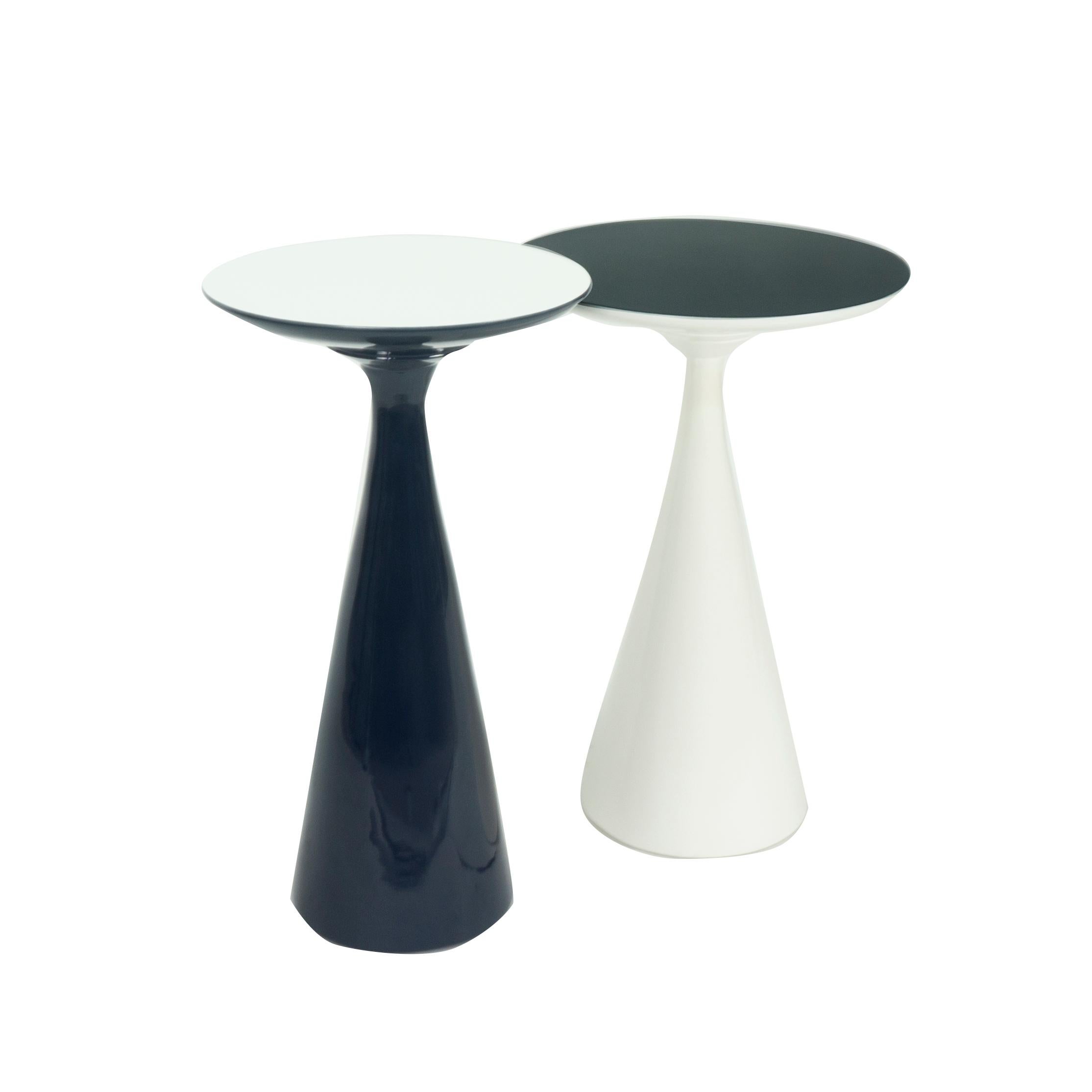 Our stiletto cocktail side tables are lacquered in white and navy blue. Together or apart they add function and beauty to a space. The pair of table are available now as is or can be custom built upon request. 

Measurements: 
White 23