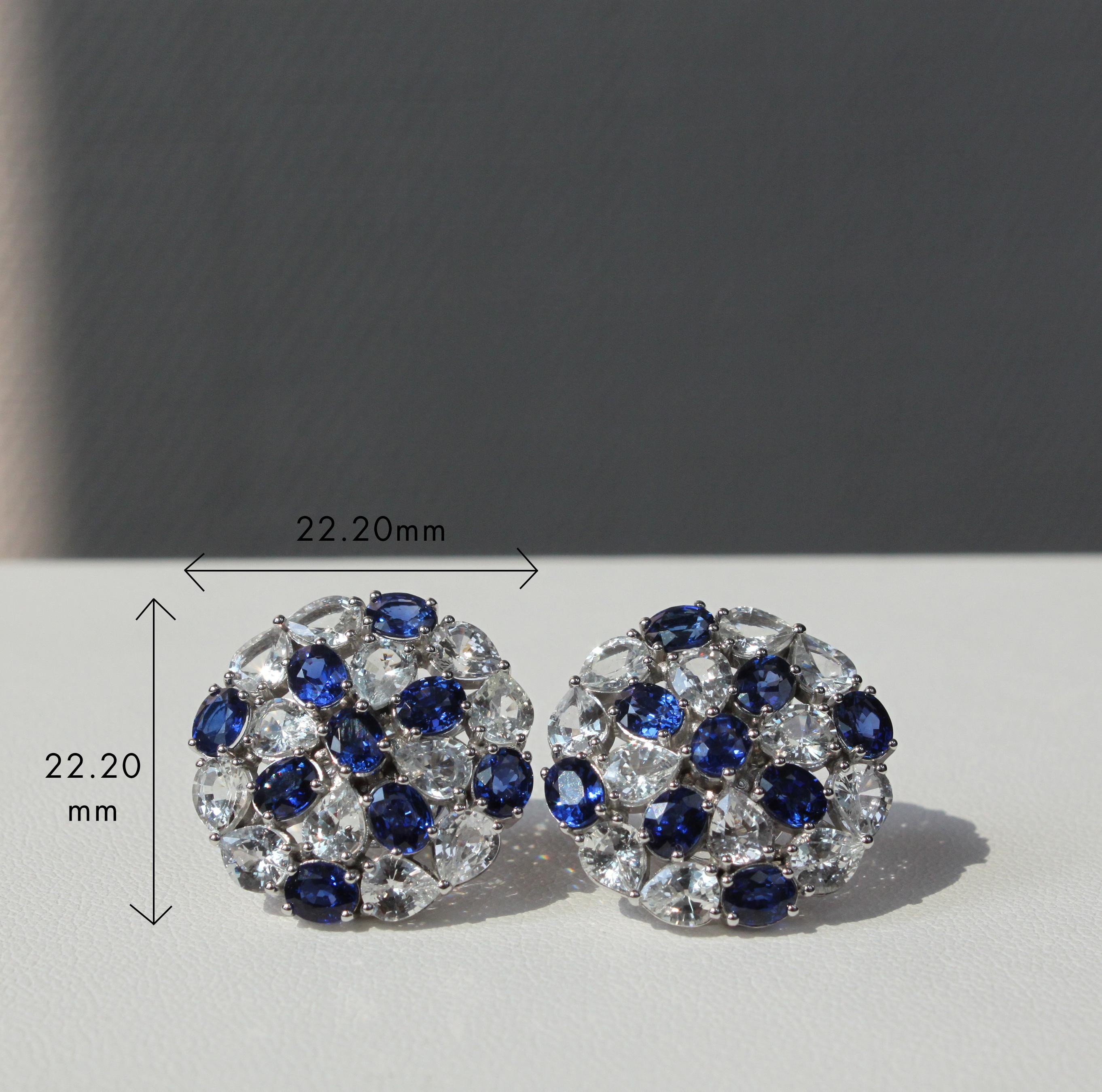 14K white gold
6.63 ct natural blue sapphire
8.45 ct natural white sapphire
Total earring weight 12.18 g

These elegant earrings showcase the captivating beauty of blue and white sapphire. The center features five oval-cut blue sapphires, creating a