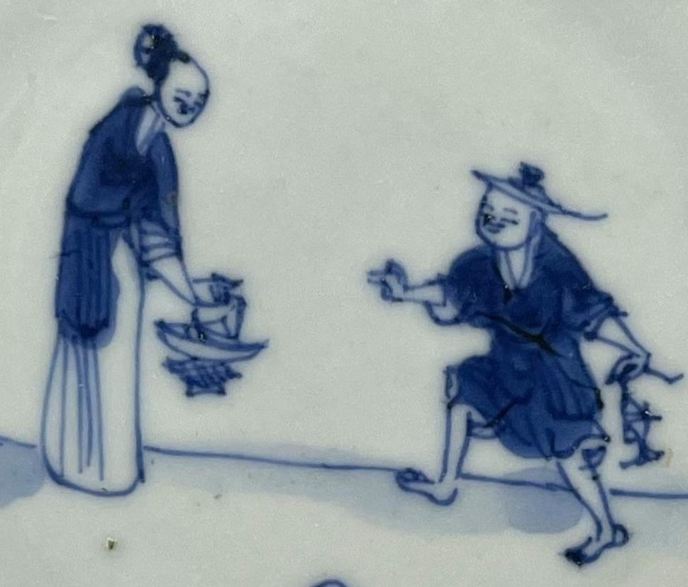 The drawing captures a scene of trade on blue and white porcelain, where a woman and a man are engaged in a transaction. The woman, dressed in traditional attire, stands with a poised demeanor, holding an object like bowl. Opposite her, the man is