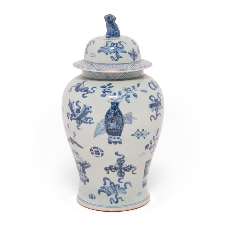 This contemporary ginger jar continues the tradition of Chinese blue-and-white ceramics with classic curves and auspicious, hand-painted decorations. Symbols that would surely give a Chinese scholar joy - yin yang, double-luck coins, censors, and