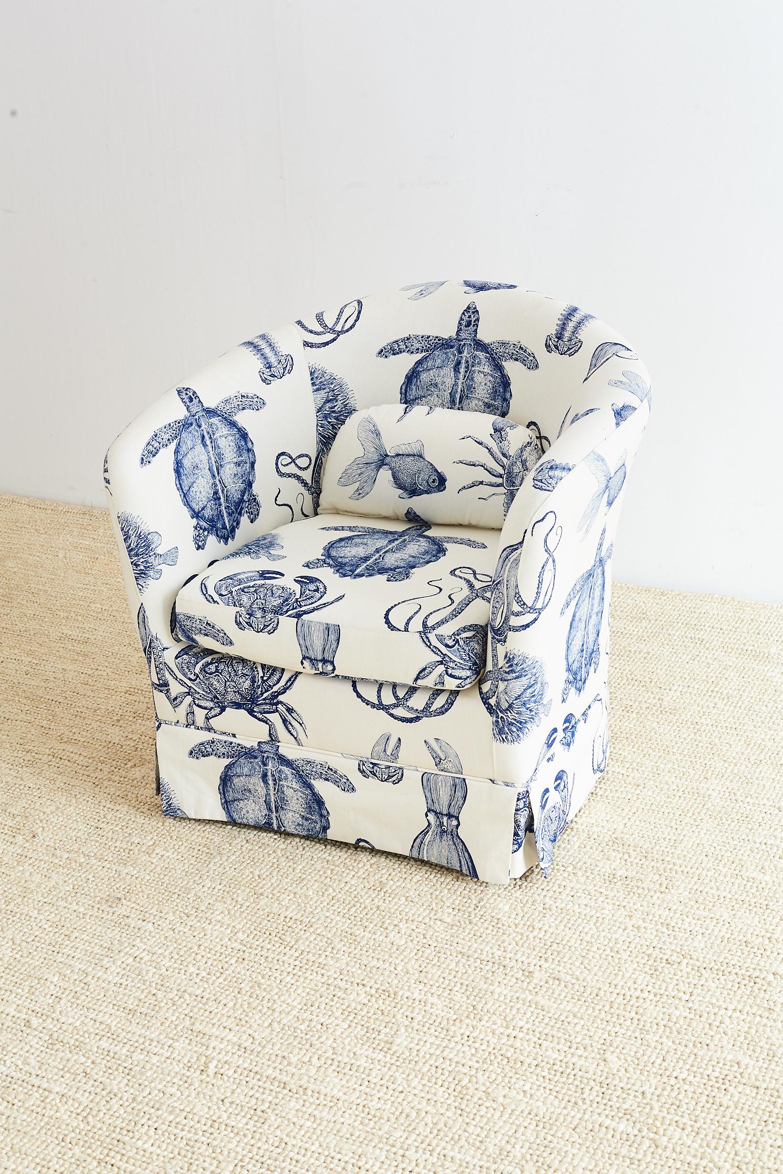 Fabulous blue and white sea life nautical upholstered club chair by Thomas Paul. Features an organic cotton heavyweight fabric printed with octopus, crabs, lobsters, turtles, puffer fish, and gold fish in indigo blue with a white ground. The chair