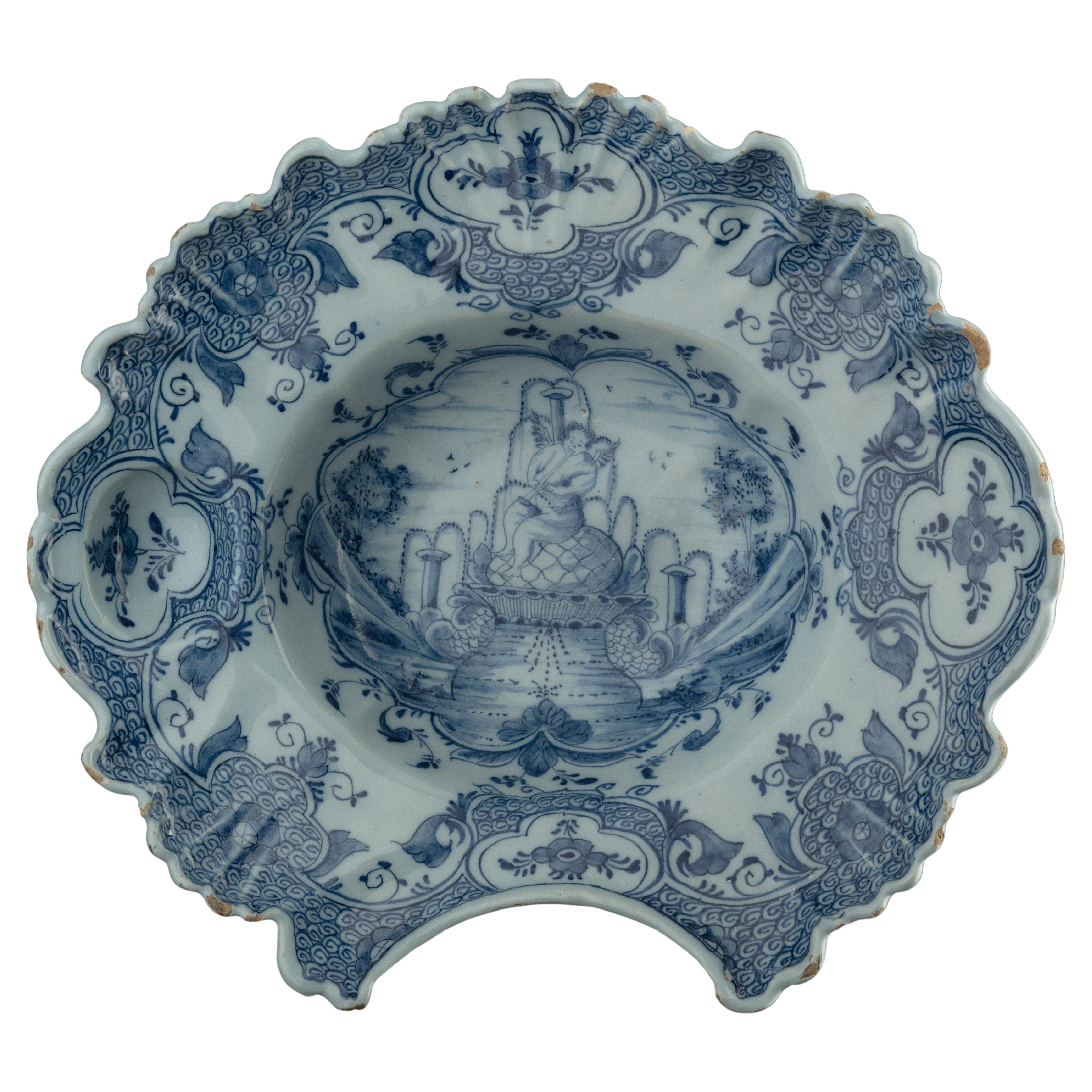 Blue and white shaving bowl with flute-playing putto Delft, 1759-1771 For Sale