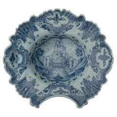 Blue and white shaving bowl with flute-playing putto Delft, 1759-1771