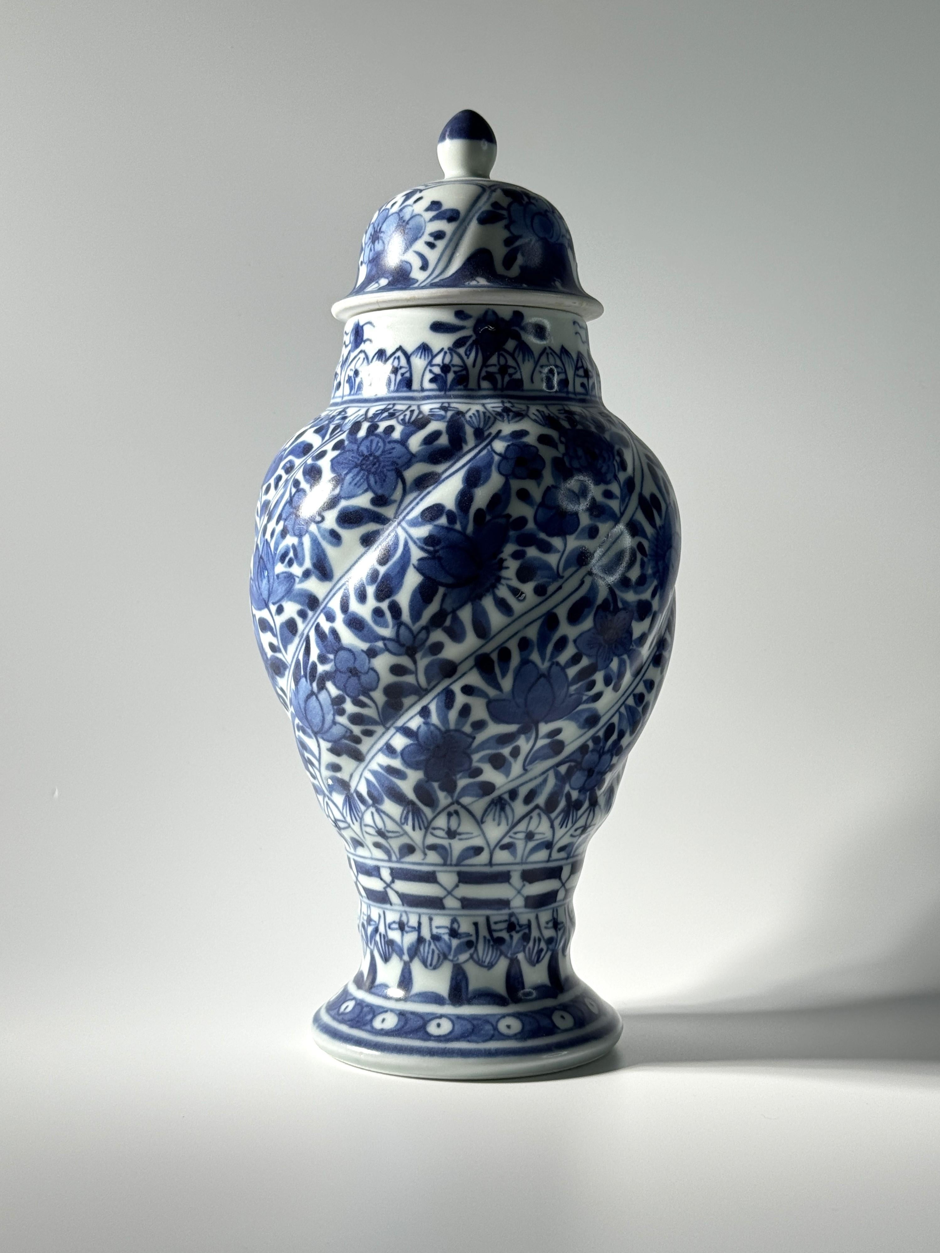 The vase and cover are decorated with flowers and foliage within each spiral band. The body of the vase tapers from the top to the bottom. This piece is characterized by a spiral shape and is one of the representative item excavated from the Vung