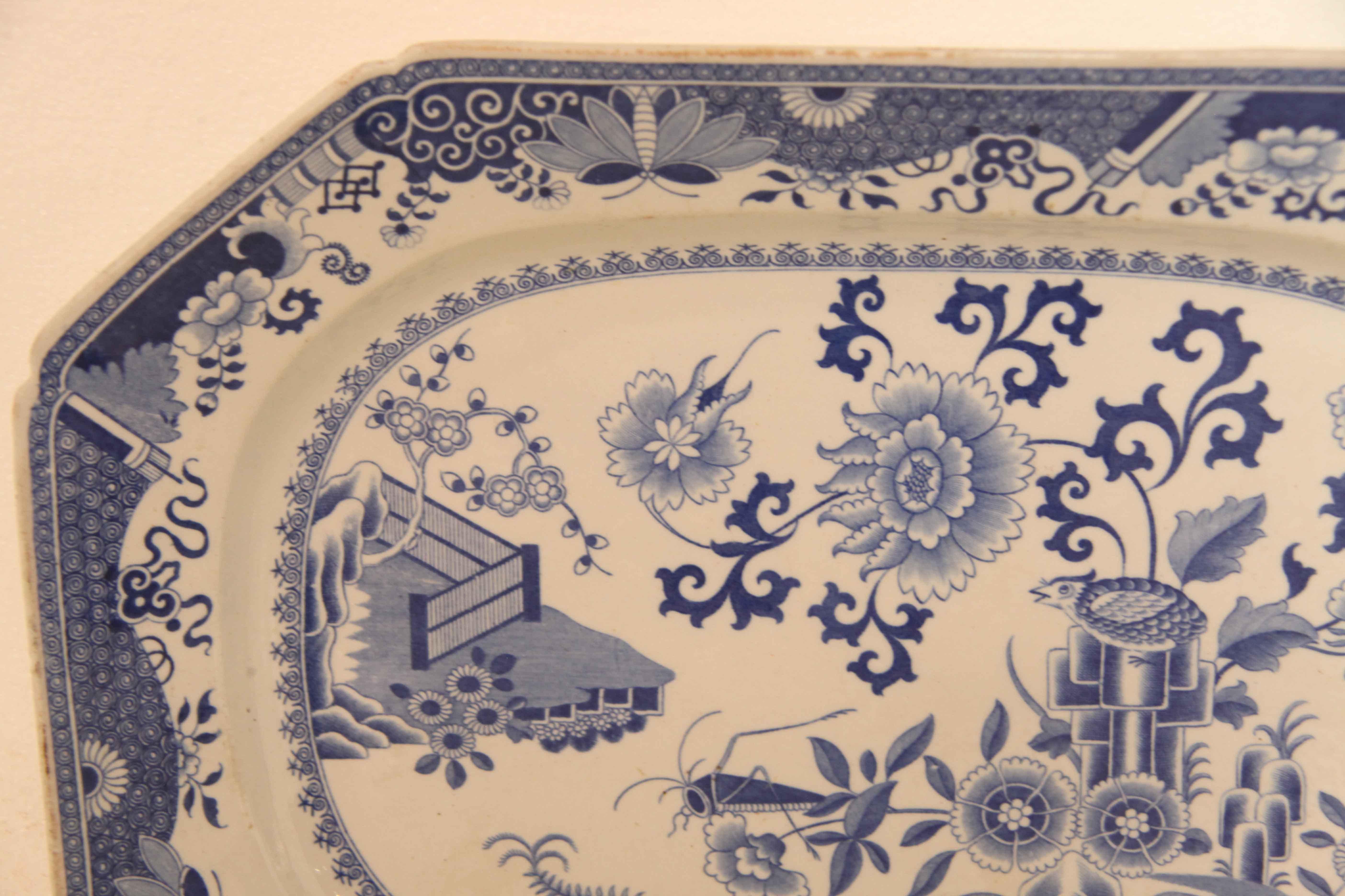 Blue and white spode platter, the pinched corner rim is followed by a border with dragonflies, flowers, foliage and various oriental motifs.  The main body features small and large flowers along with trailing foliage, a bird and dragonfly.  The mark