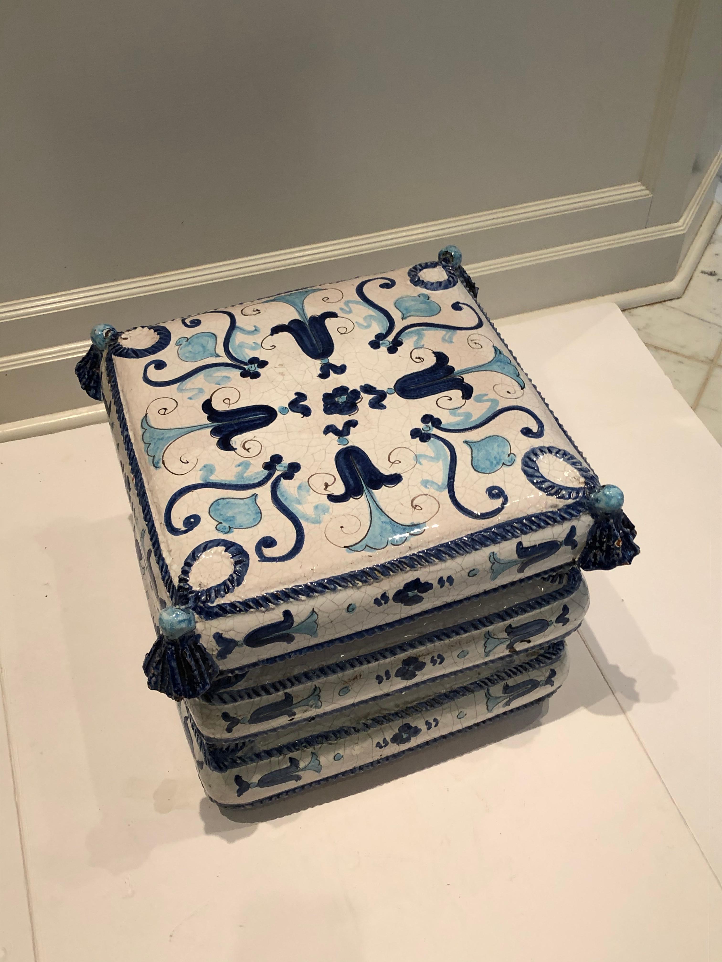 Stylish blue and white ceramic garden seat end table from Italy. Charming hand painted details in varying shades of blue which include bell flowers, roping and tassels. Lovely used indoors or on the patio.
       