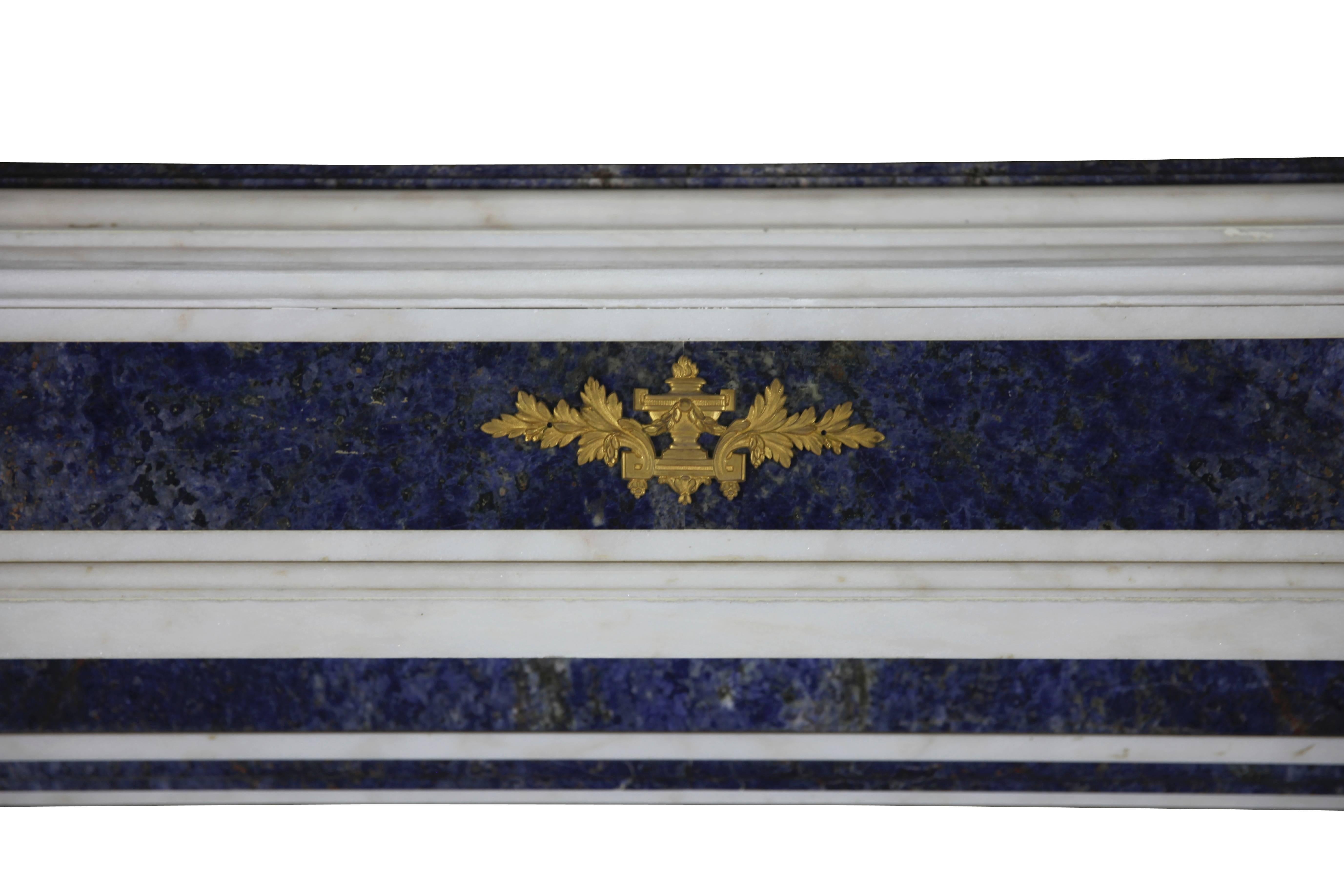 This amazing, one of a kind fireplace mantel, surround is in perfect condition; it was made by special order for a Parisian salon (France). It is crafted from white statuary marble with Brazilian blue Baya Marble; this is a very unusual combination.