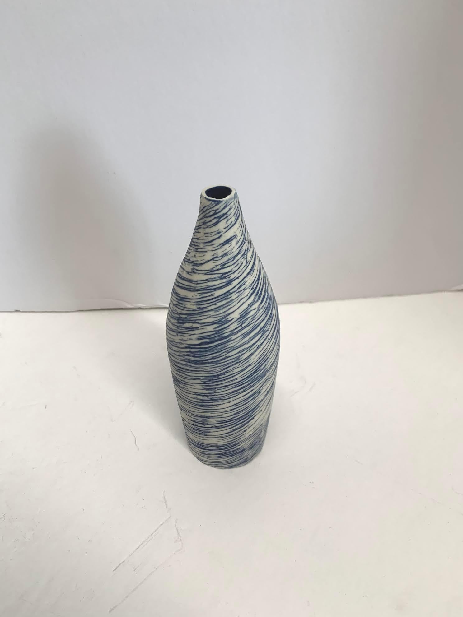 Contemporary Italian hand made ceramic blue and white swirl design vase.
Matte glaze.
Part of a large collection of blue and white diminutive vases.
See image #5.