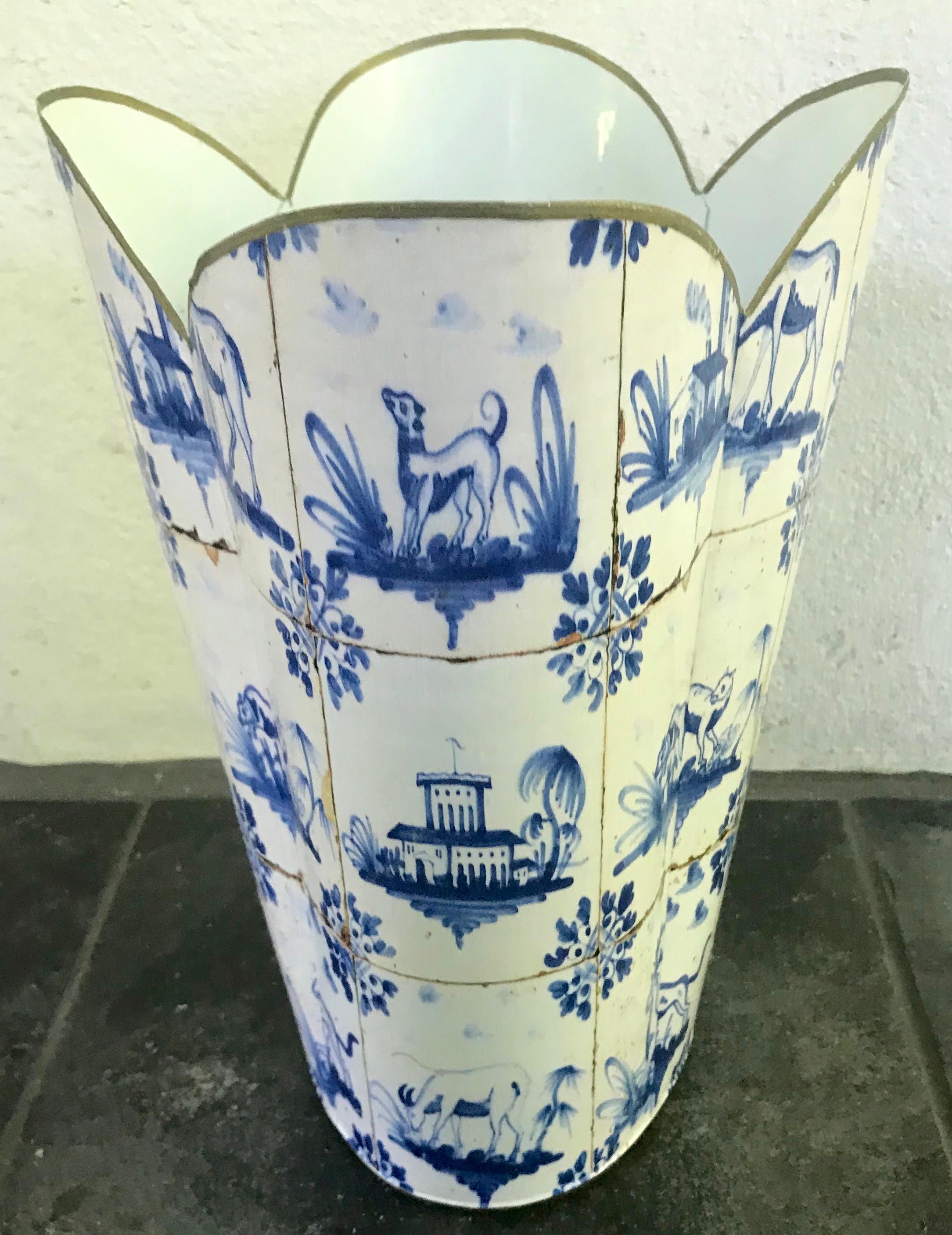 Blue and white tole wastebasket. Dutch tile print lacquered litter basket with oval base rising to an outward shaped gilt scalloped top. Contemporary fresh Dutch look in rich blue and white. United States, 20th century.
Dimensions: 12” H x 10.5” L
