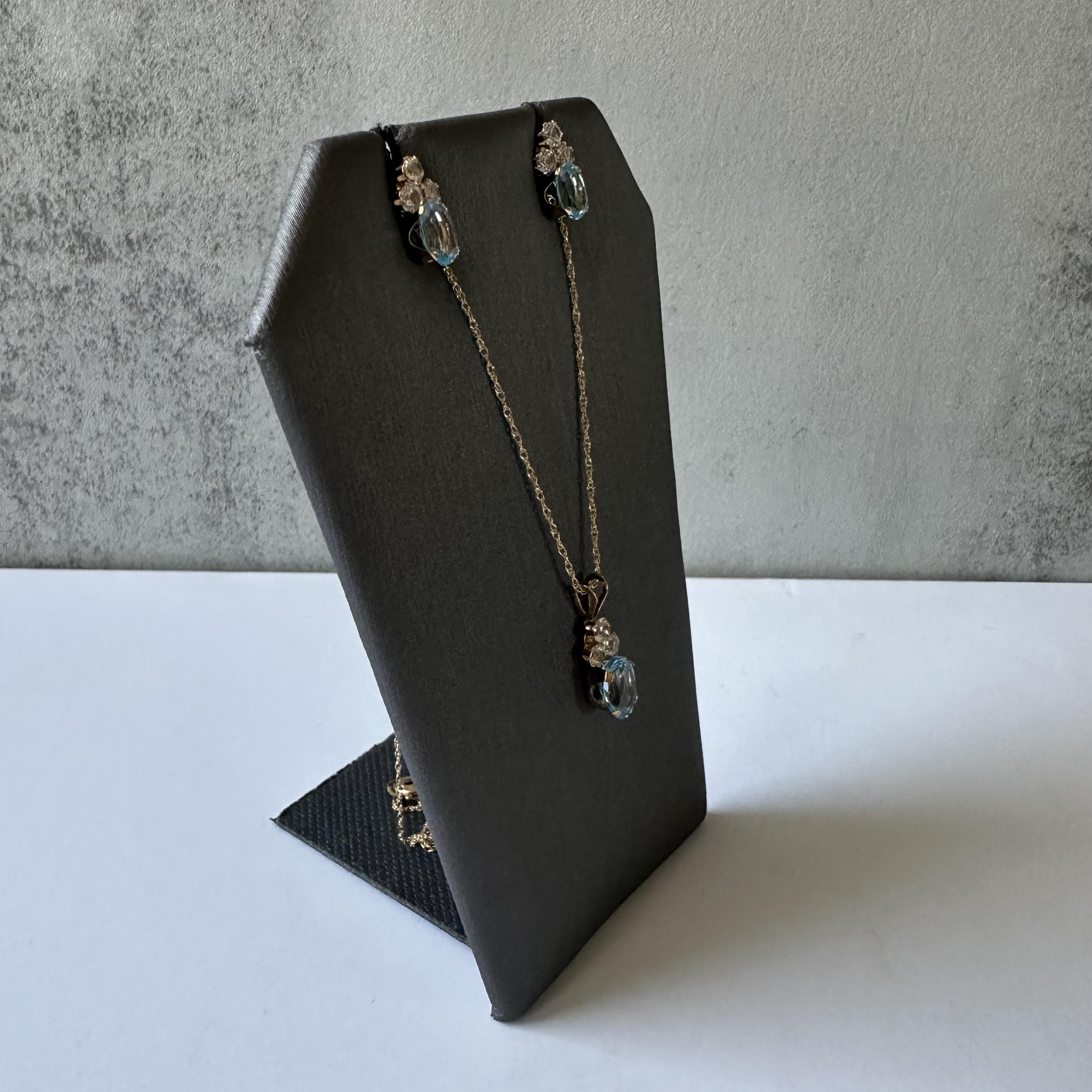 Enhance your jewelry collection with this stunning Blue and White Topaz Earrings and Necklace Set in elegant 10kt Yellow Gold. This 2-piece set offers the perfect combination of beauty and style, featuring brilliant blue and white topaz stones that