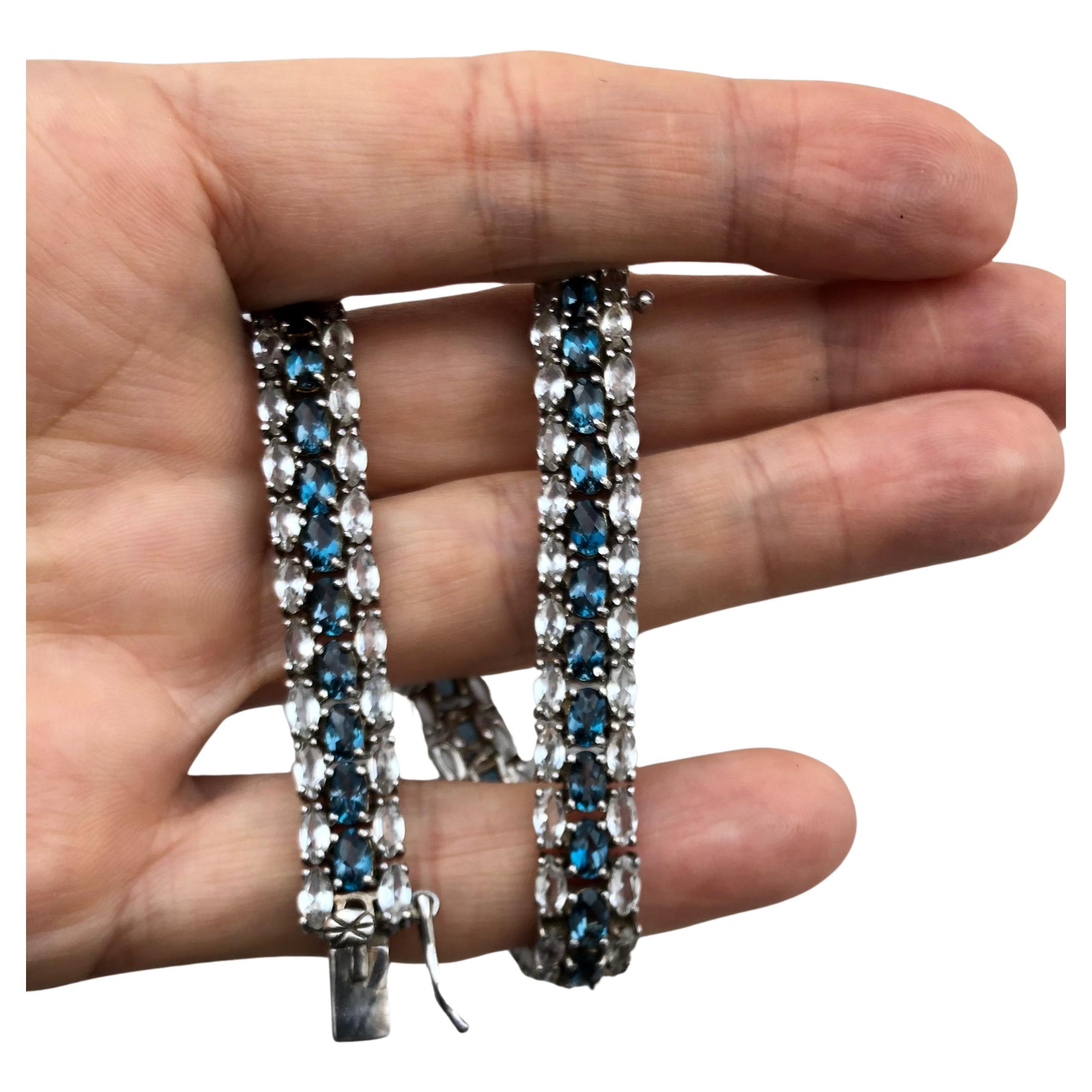 Stunning blue and white natural topaz and sterling silver three line, link bracelet. Total length 8.20 inches and 0.39 inch wide. About 29.38 grams. 