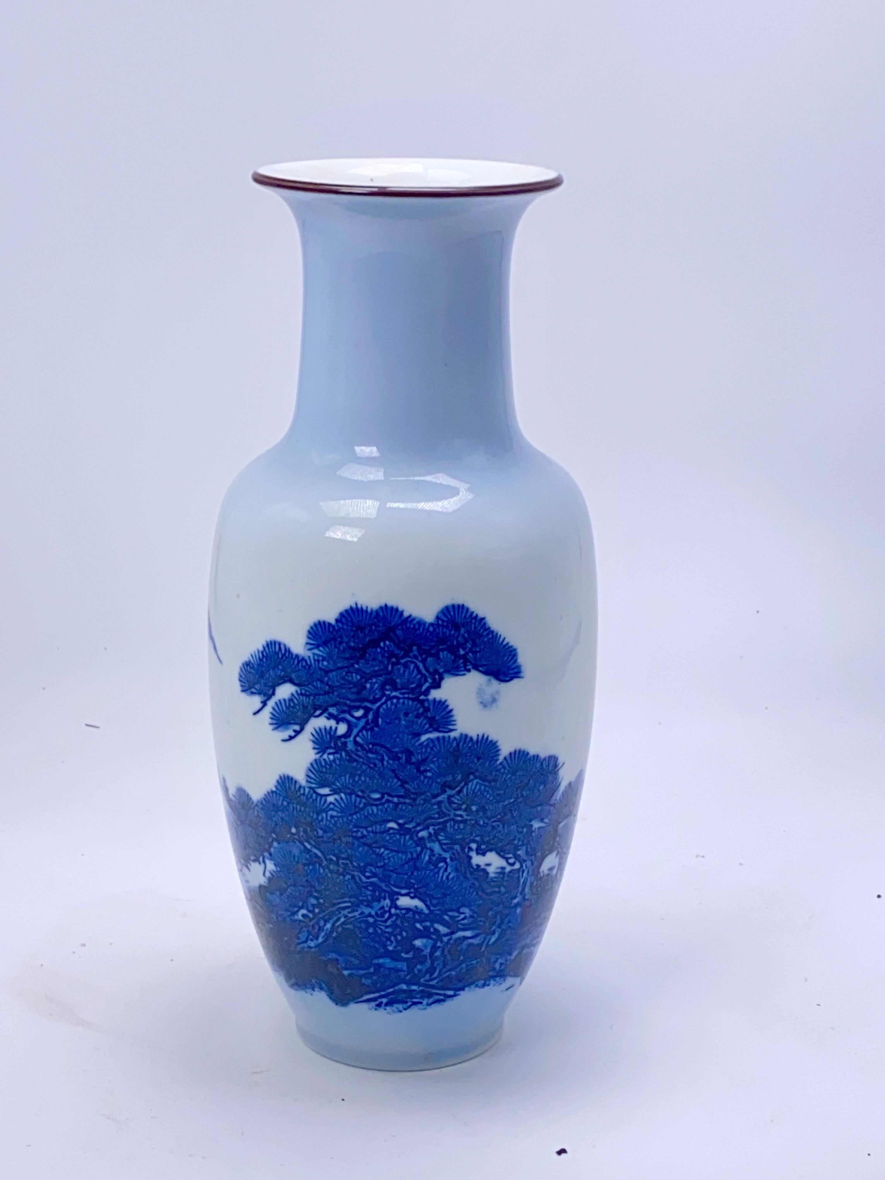 20th century Chinese blue and white vase features fishes pattern, cobalt blue on a Classic shape formed from pure white Kaolin clay. Such examples were produced in China for the lucrative European and Middle Eastern market, and continue to be