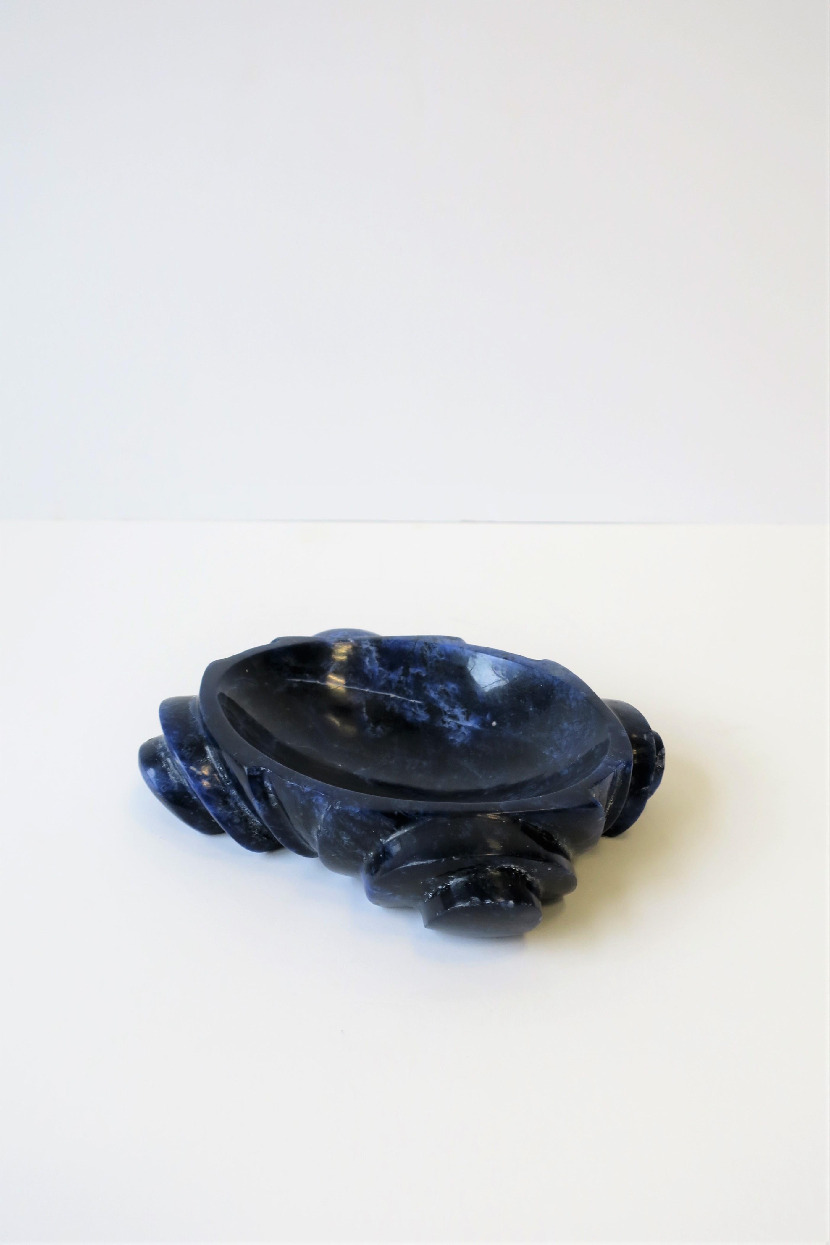 A beautiful blue and white oval carved sodalite stone dish/bowl/vessel. Piece is shown in images as a jewelry dish, but can work equally well for other small items including as a soap dish. 

Piece measures: 4.25 in. D x 5.25 in. D x 1.5 in. H


