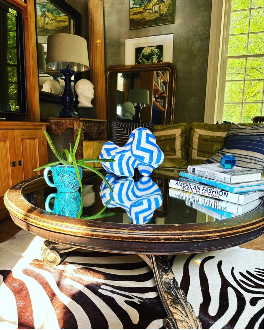 biomorphic ceramic sculpture in blue and white.  hand painted bright blue geometric pattens over an undulating white form. the painted 
patterns collide and create optical illusions that disguise the shape of the form, playing tricks on your eyes. 

