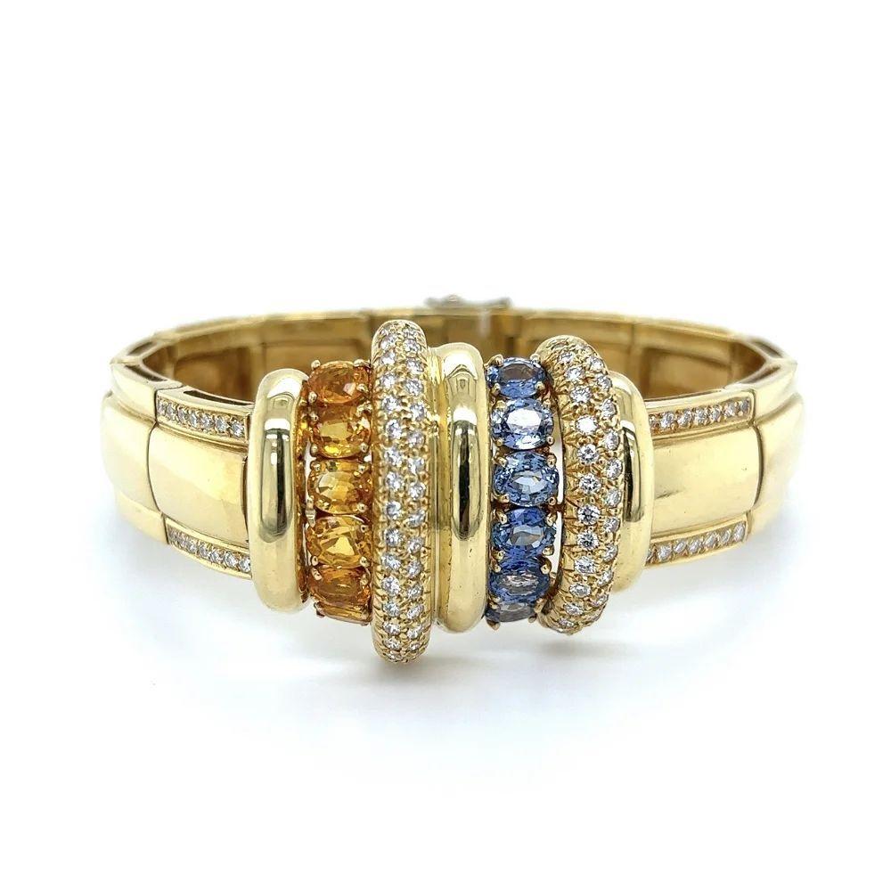 Simply Beautiful! Finely detailed Blue and Yellow Sapphire Diamond Vintage Gold hinged Clamper Bracelet. Securely Hand set with Blue and Yellow Sapphires, weighing approx. 8.50tcw and Diamonds, approx. 2.25tcw. Measuring approx. 7”. More Beautiful