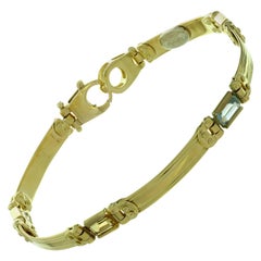 Bracelet italien en or jaune composé de topazes bleues et jaunes