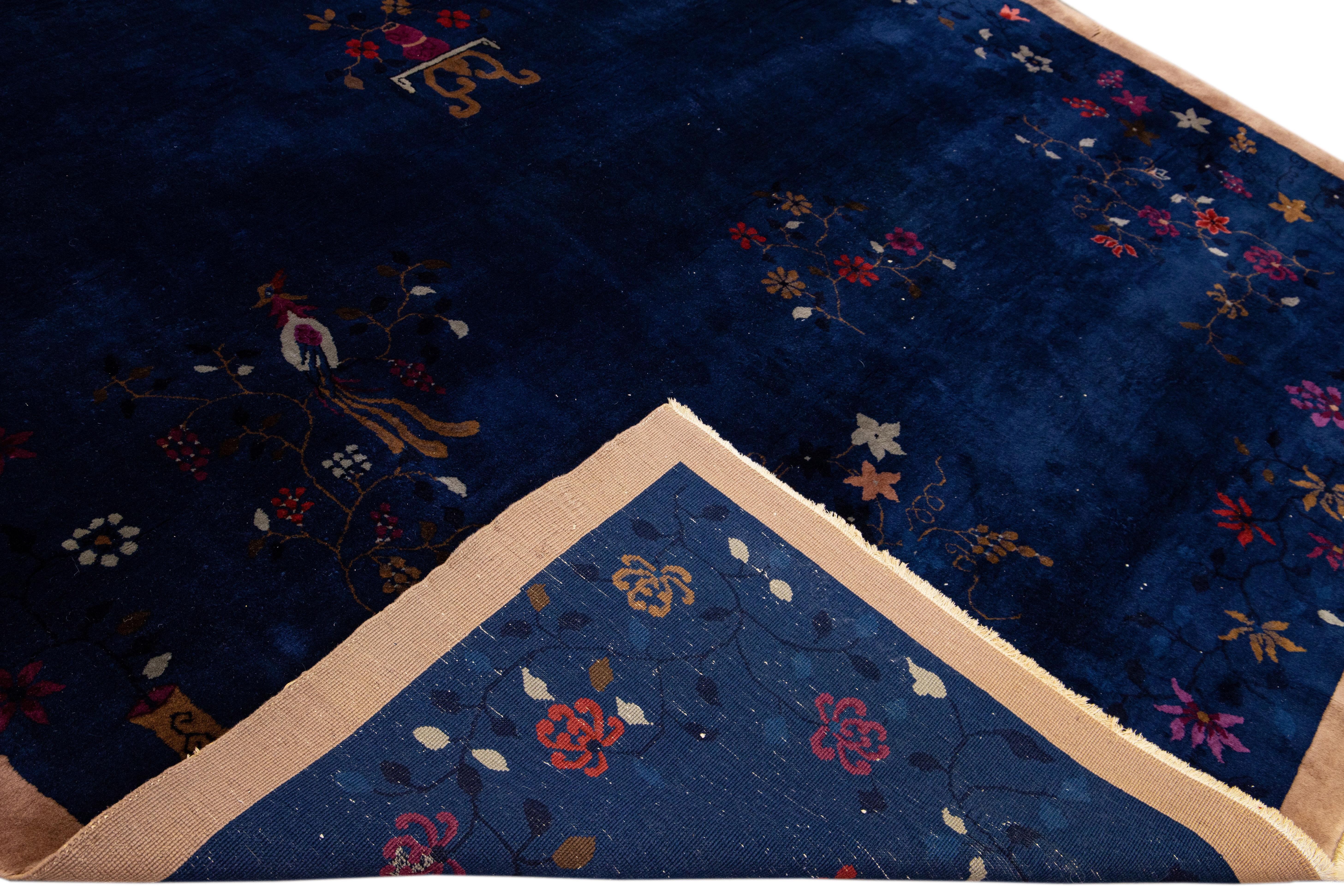 Schöner antiker chinesischer Art-Déco-Teppich aus handgeknüpfter Wolle mit einem blauen Feld. Dieser chinesische Teppich hat einen braunen Rahmen, mehrfarbige Akzente und ein wunderschönes chinesisches Blumenmuster. 

Dieser Teppich misst: 9' x