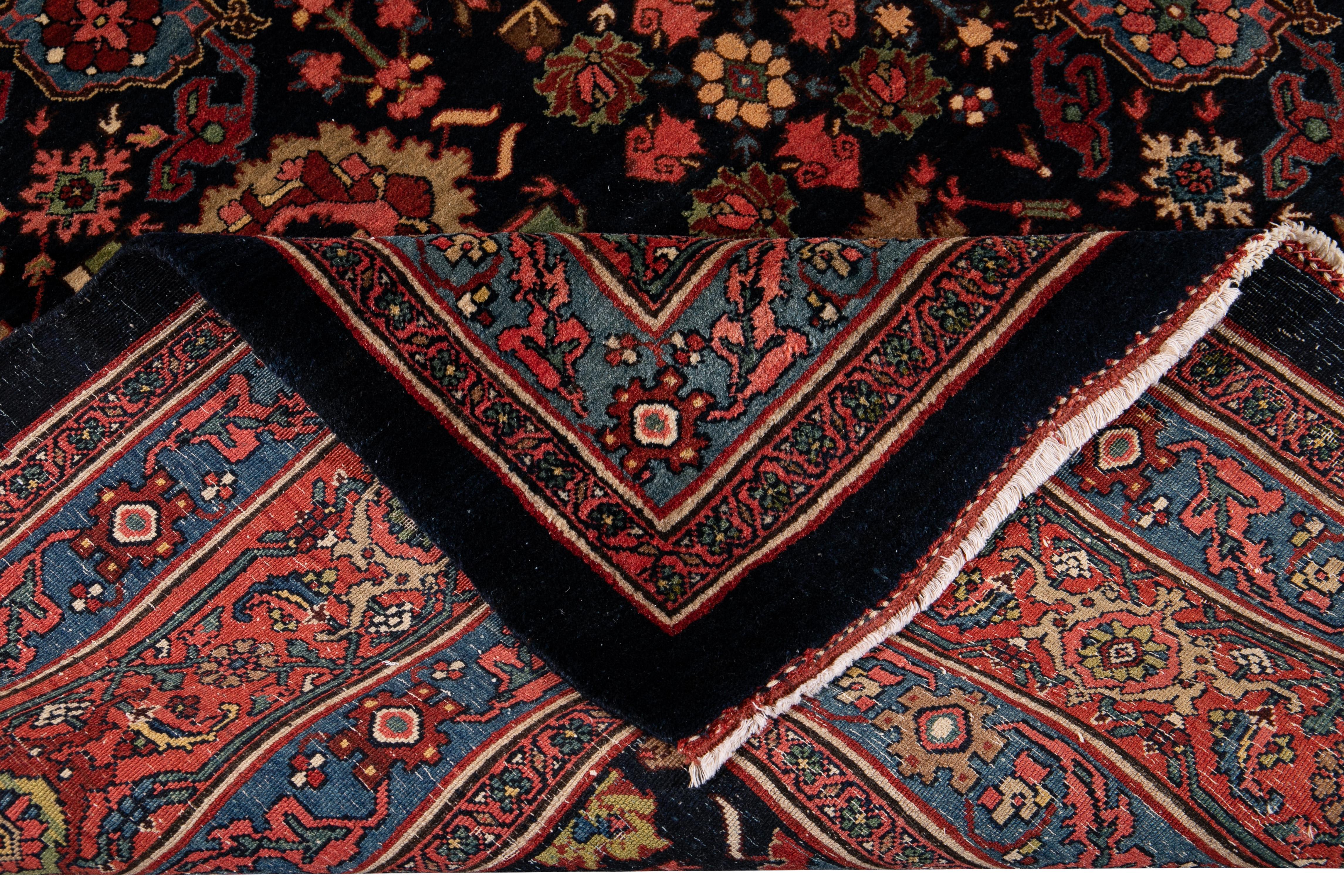 Beautiful Antique Persian Bidjar Hand-knotted wool rug with a blue field. This rug has a blue, red frame and multi-color accents in an all-over floral design. 

circa 1920

This rug measures 8' 8