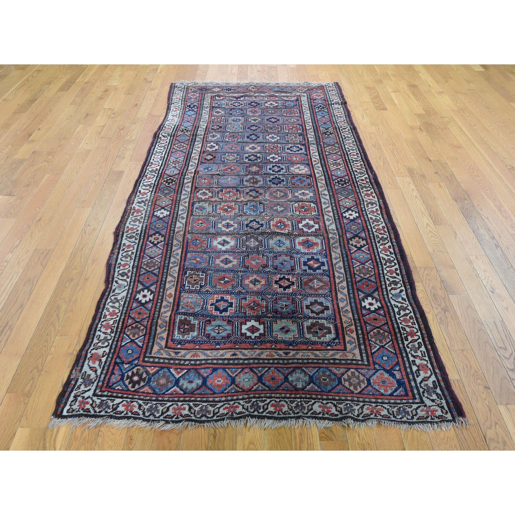This is a truly genuine one-of-a-kind blue antique Caucasian Kazak even wear wide runner hand knotted rug. It has been knotted for months and months in the centuries-old Persian weaving craftsmanship techniques by expert artisans. 

Primary