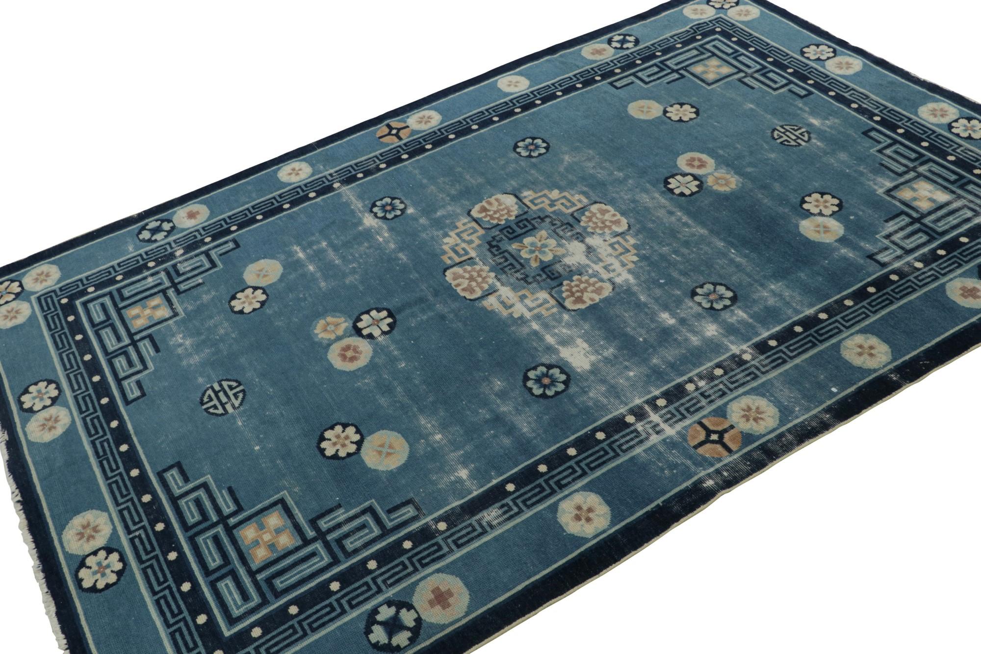 Originating from China, circa 1920-1930, this 5x8 antique Chinese Art Deco Peking rug, hand-knotted in wool, features regal floral patterns and borders on a blue field. 

On the Design: 

Peking rugs were known for unique colors and sizes—most