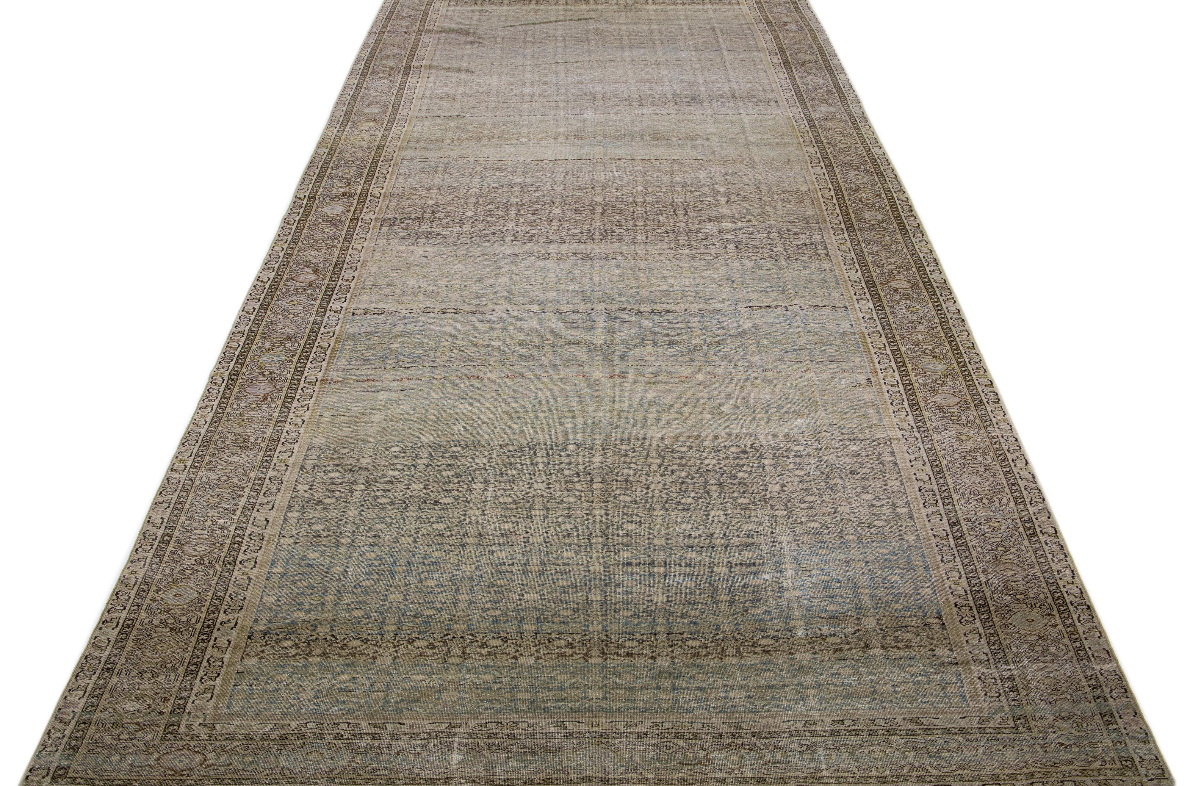 Beautiful antique Malayer hand knotted wool rug with a blue color field. This Persian rug has brown, tan, and gray accents in a gorgeous all-over floral design.

This rug measures: 8'2