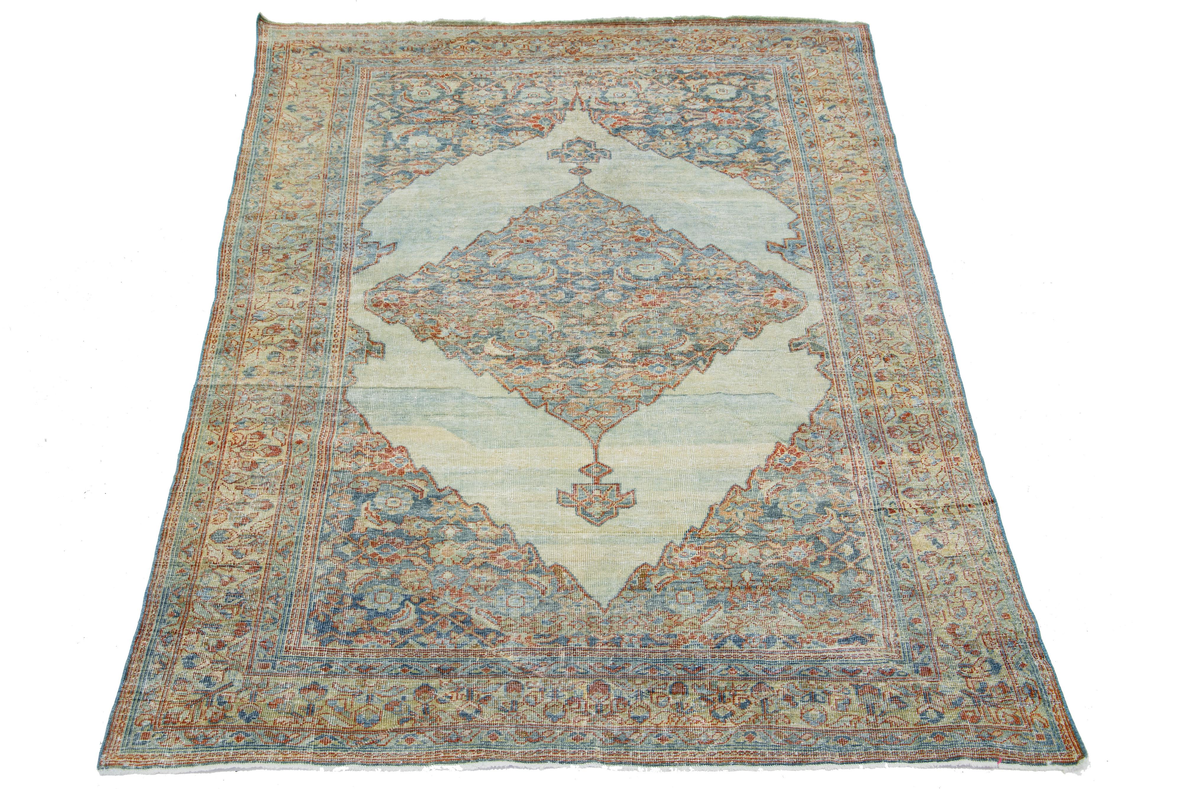 Beautiful antique Persian Mahal hand-knotted wool rug with a blue field. This piece has a beige-designed frame with red accents in a gorgeous all-over floral design.

This rug measures 5'9