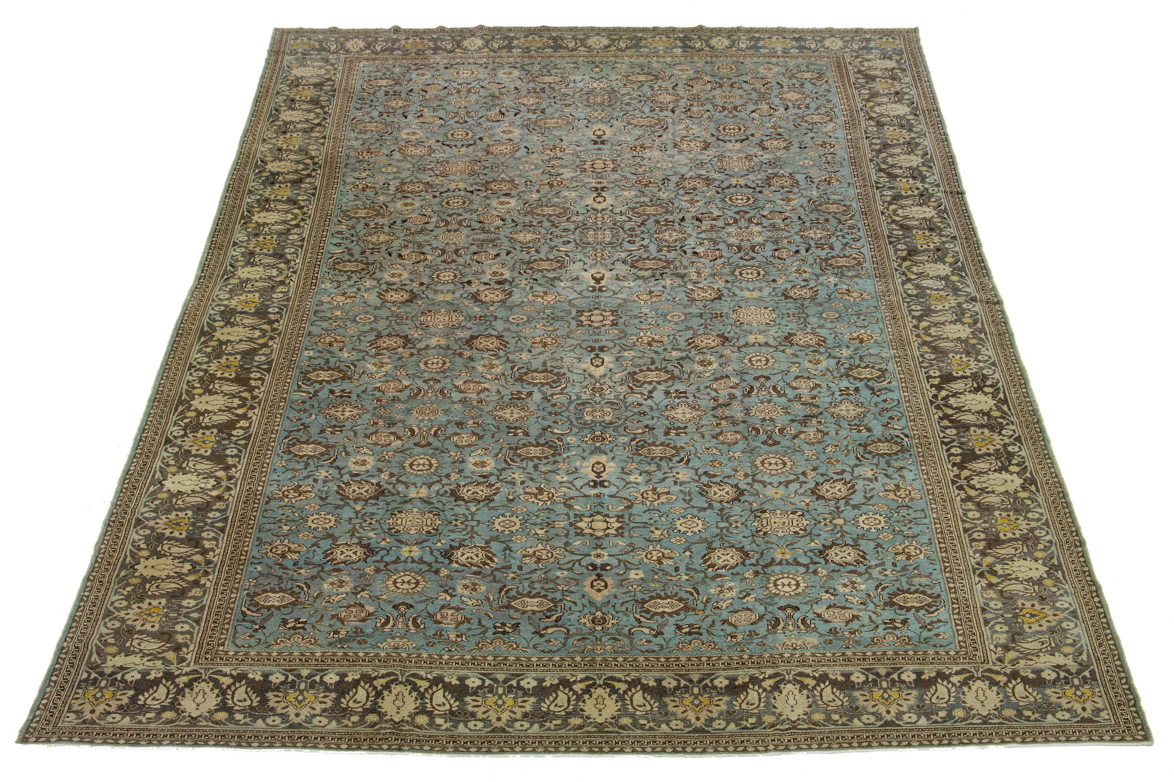 Beautiful antique Malayer hand-knotted wool rug with a blue field. This Persian piece has a gray frame with yellow, beige, and brown accents in a gorgeous all-over floral design.

This rug measures: 11'8