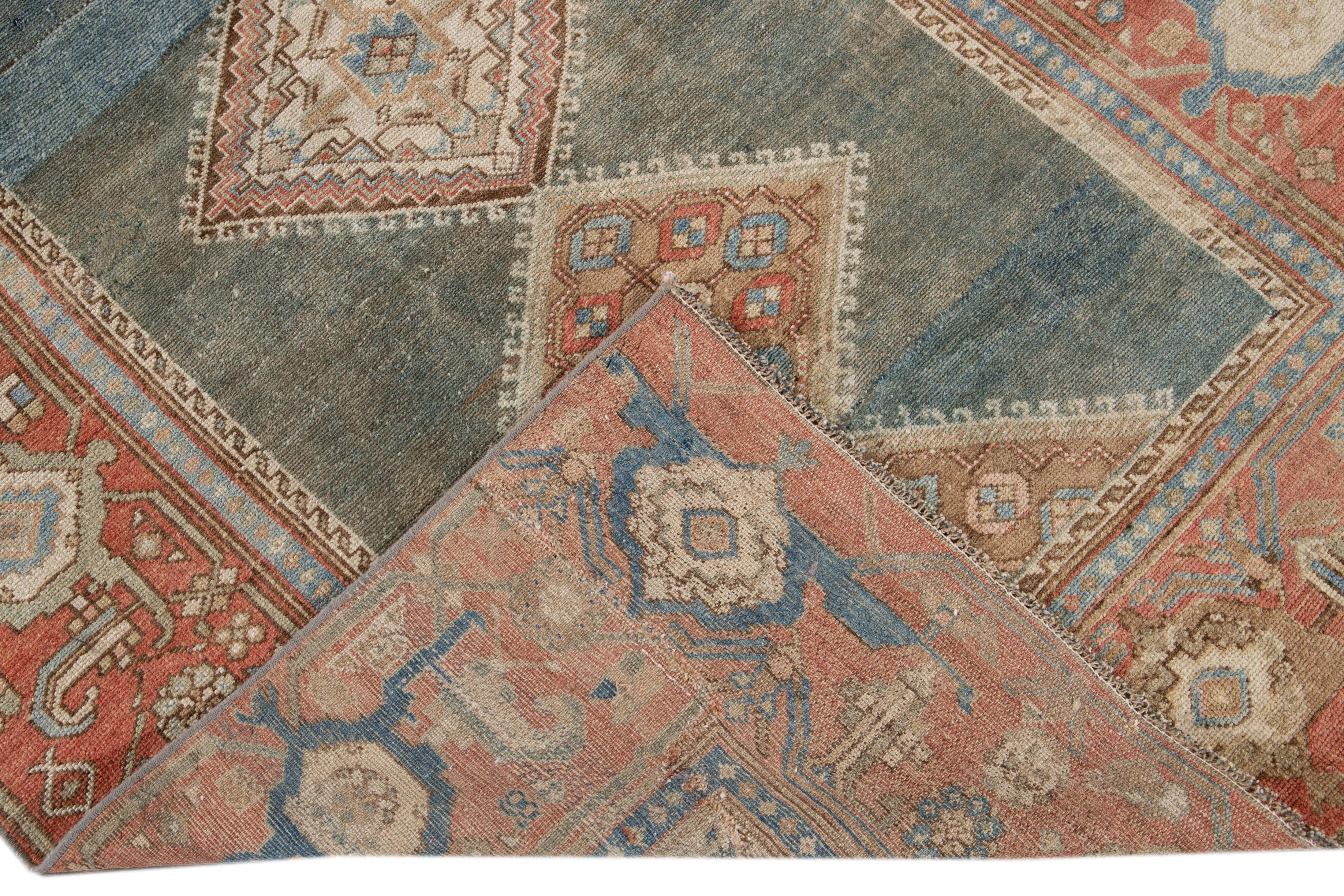 Beautiful antique Malayer hand knotted wool runner with a blue field. This Malayer rug has a rust frame and accents of beige, ivory, and peach in an all-over gorgeous geometric floral design.

This rug measures: 4'1
